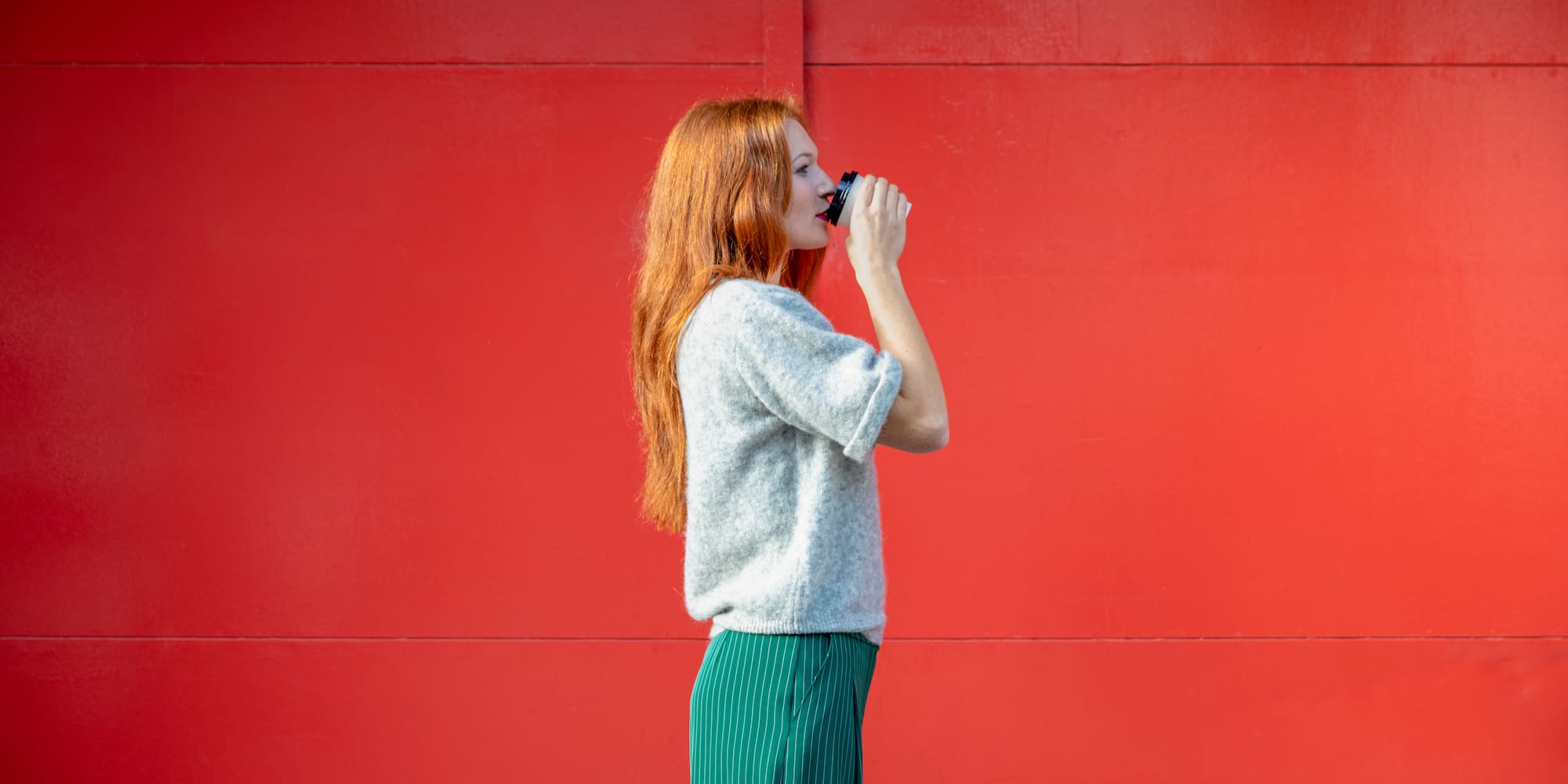 a woman drinking from a cup