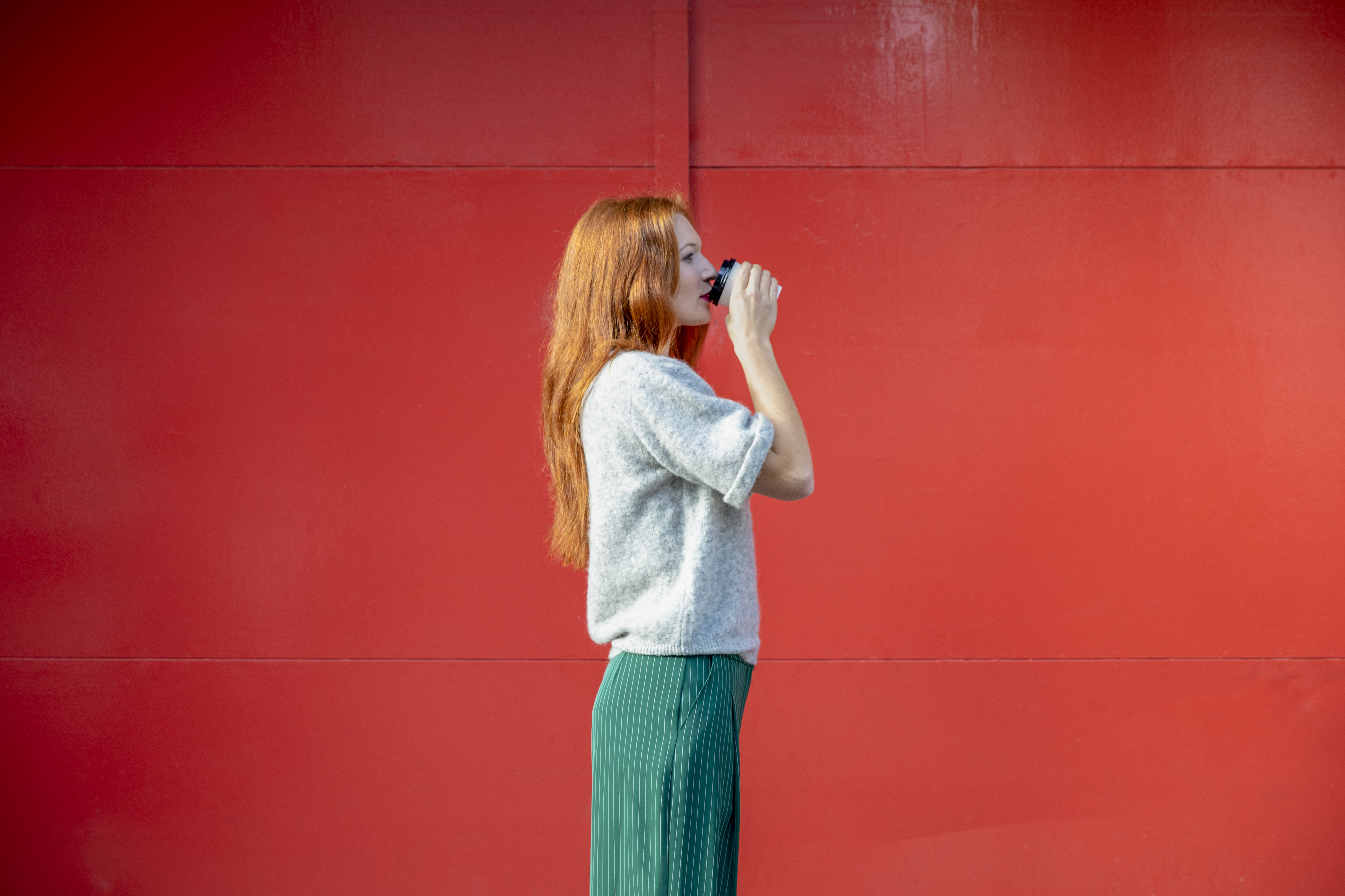 a woman drinking from a cup