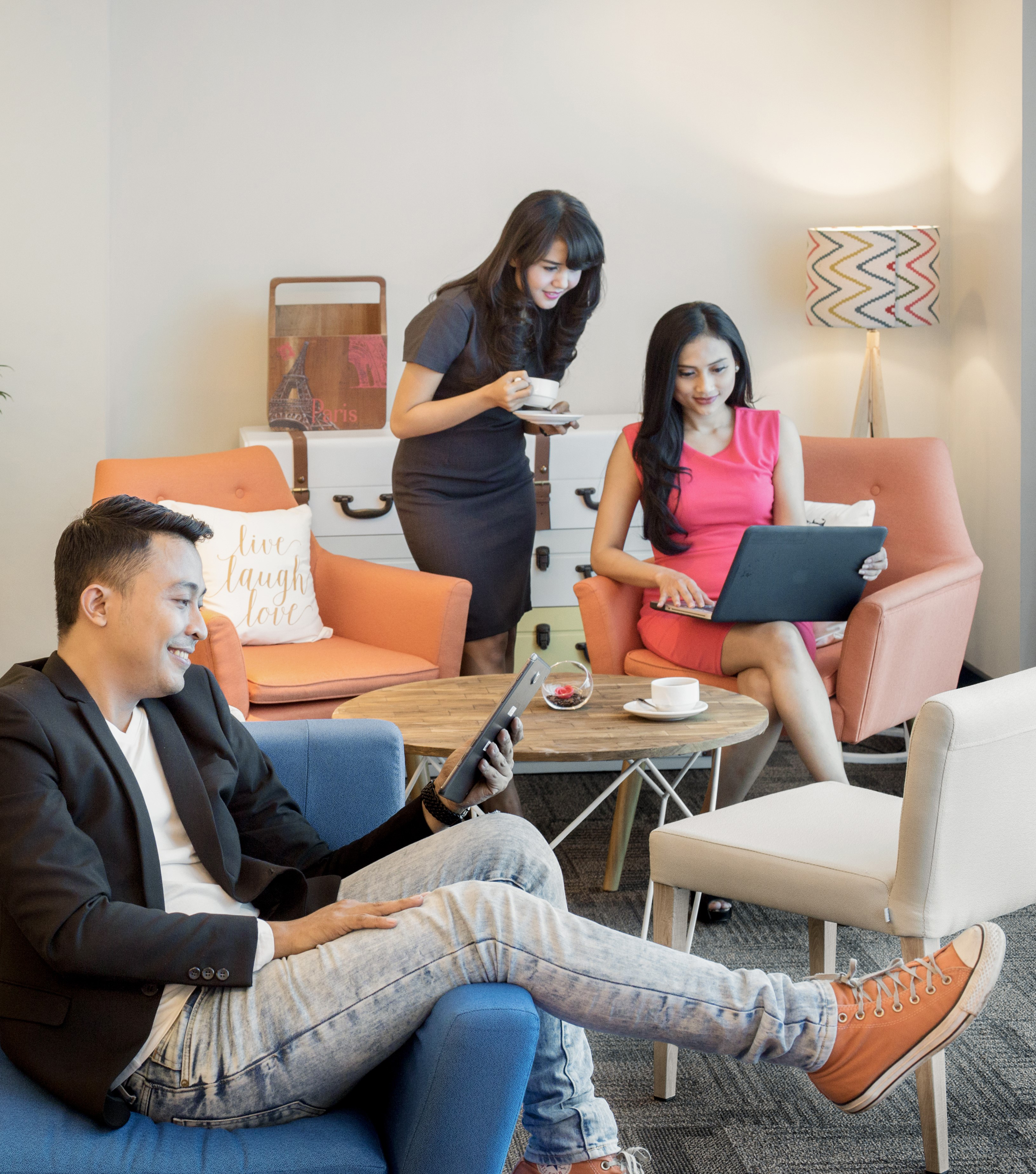 a group of people sitting in chairs and using devices