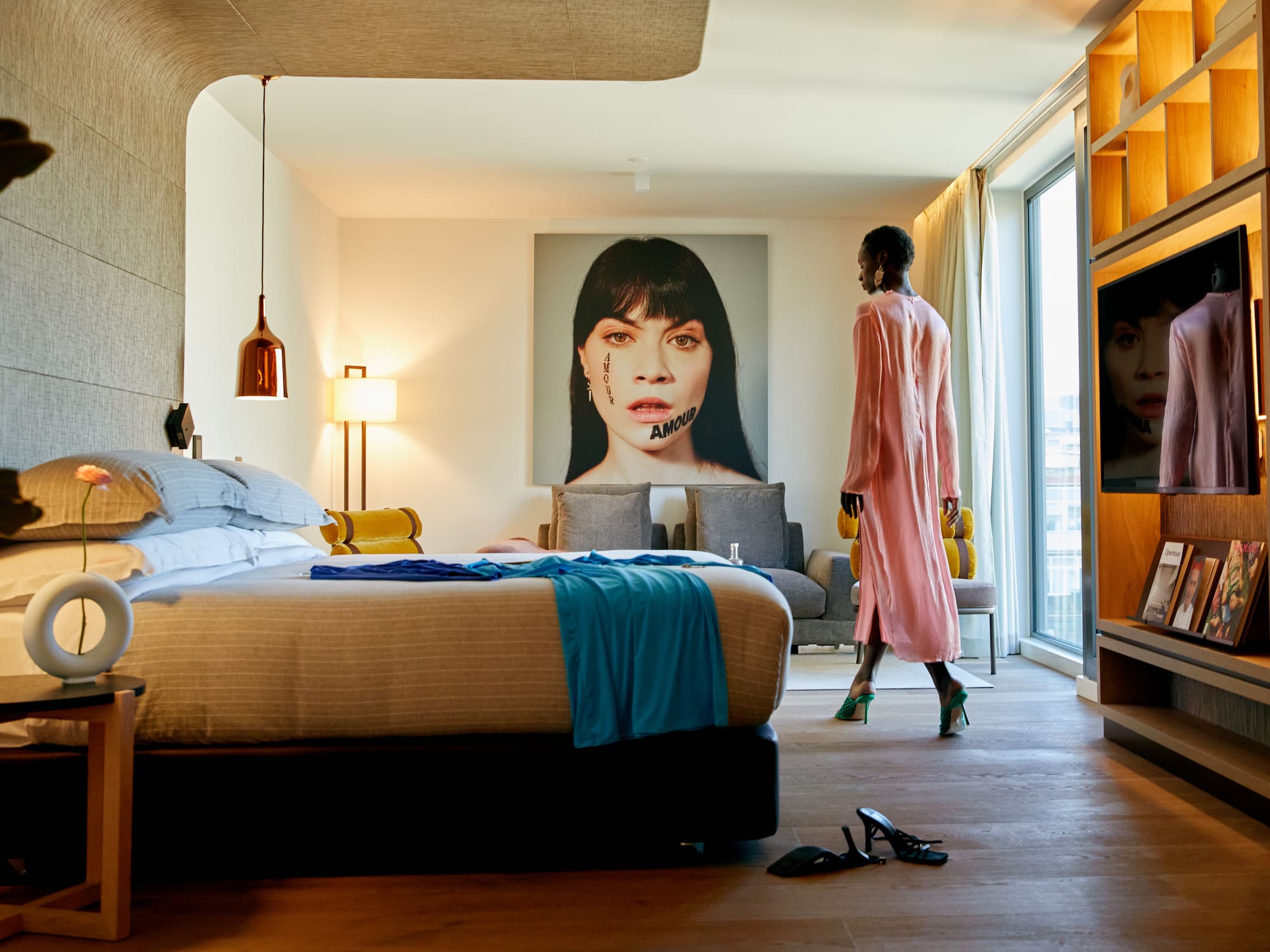 a woman walking in a hotel room
