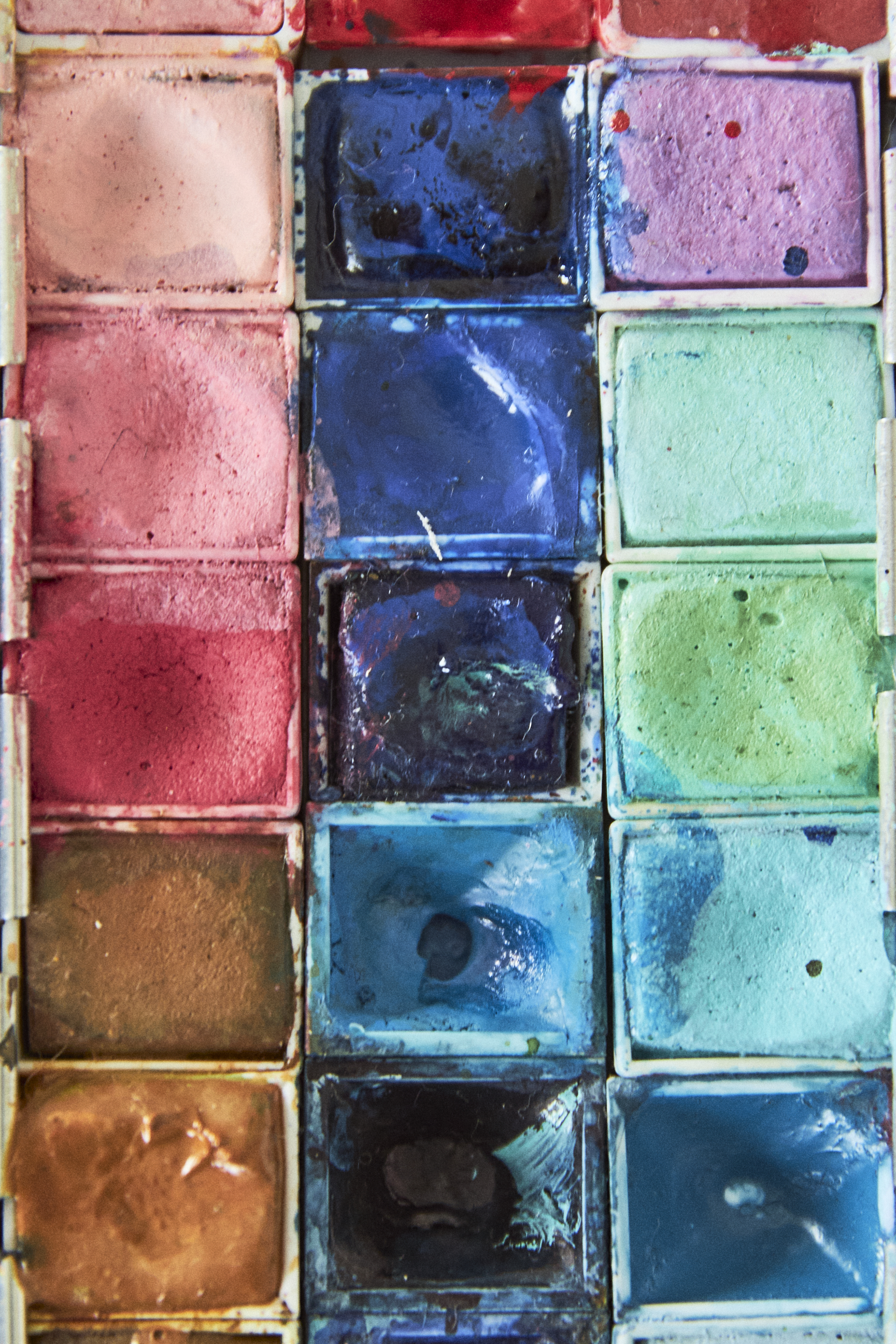 a group of watercolors in a white container