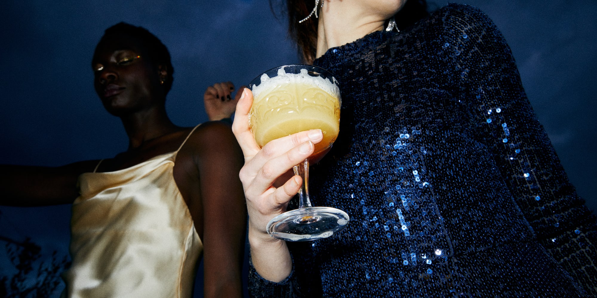 a woman holding a drink