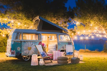 a camper van with lights and chairs