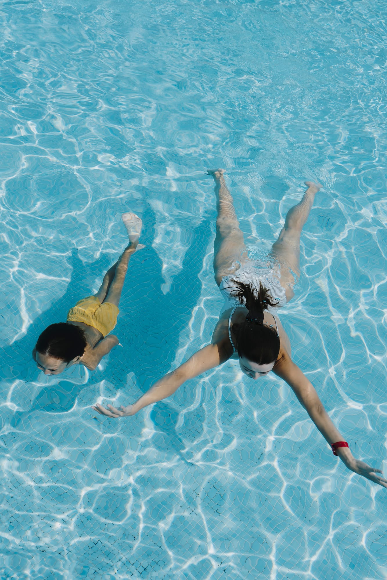 two women swimming in a pool