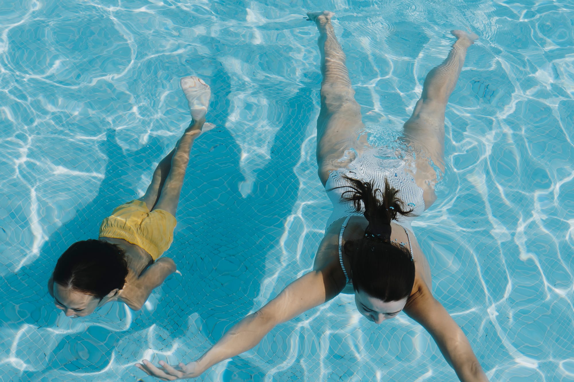 two women swimming in a pool