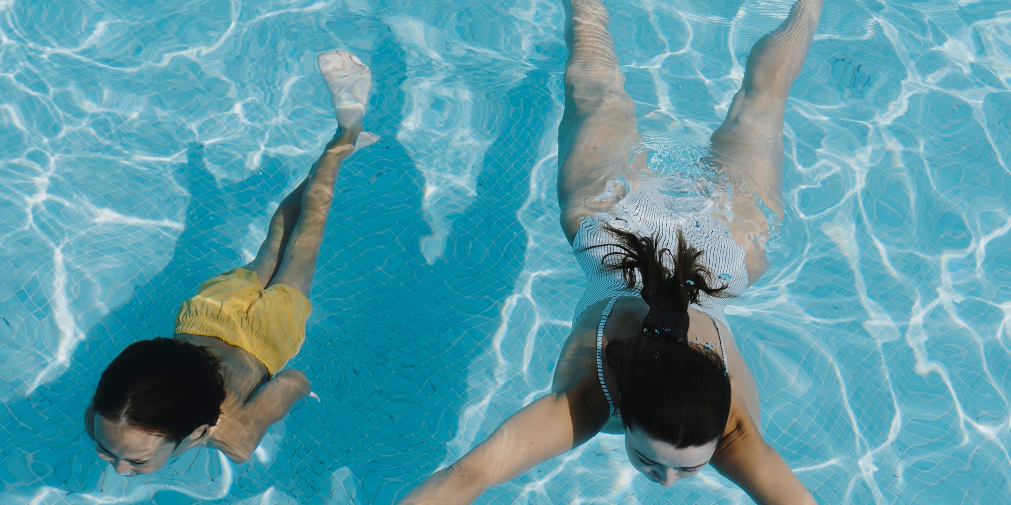 two women swimming in a pool