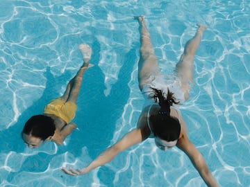 two women swimming in a pool