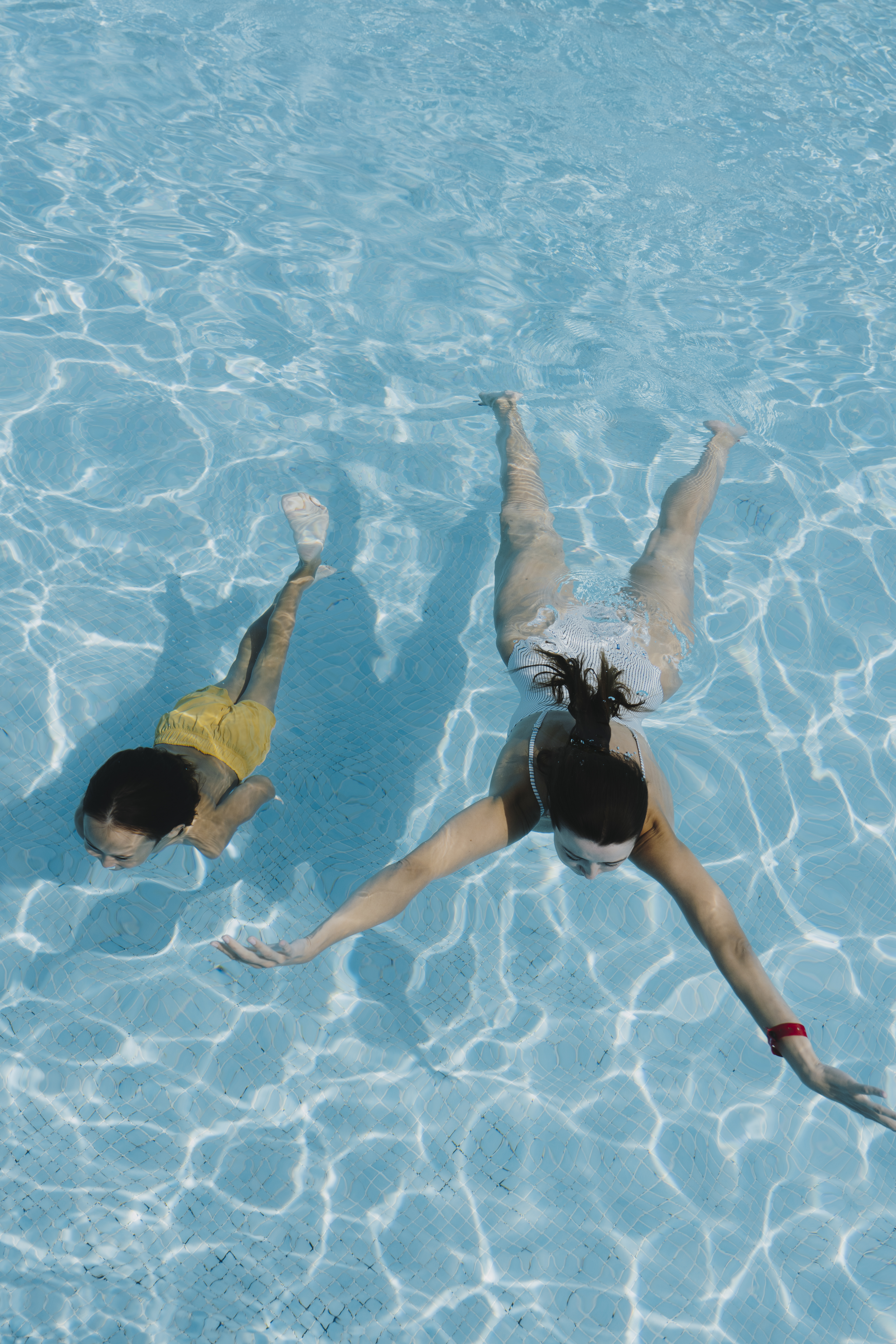 two women swimming in a pool