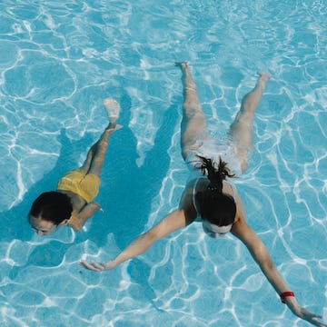 two women swimming in a pool