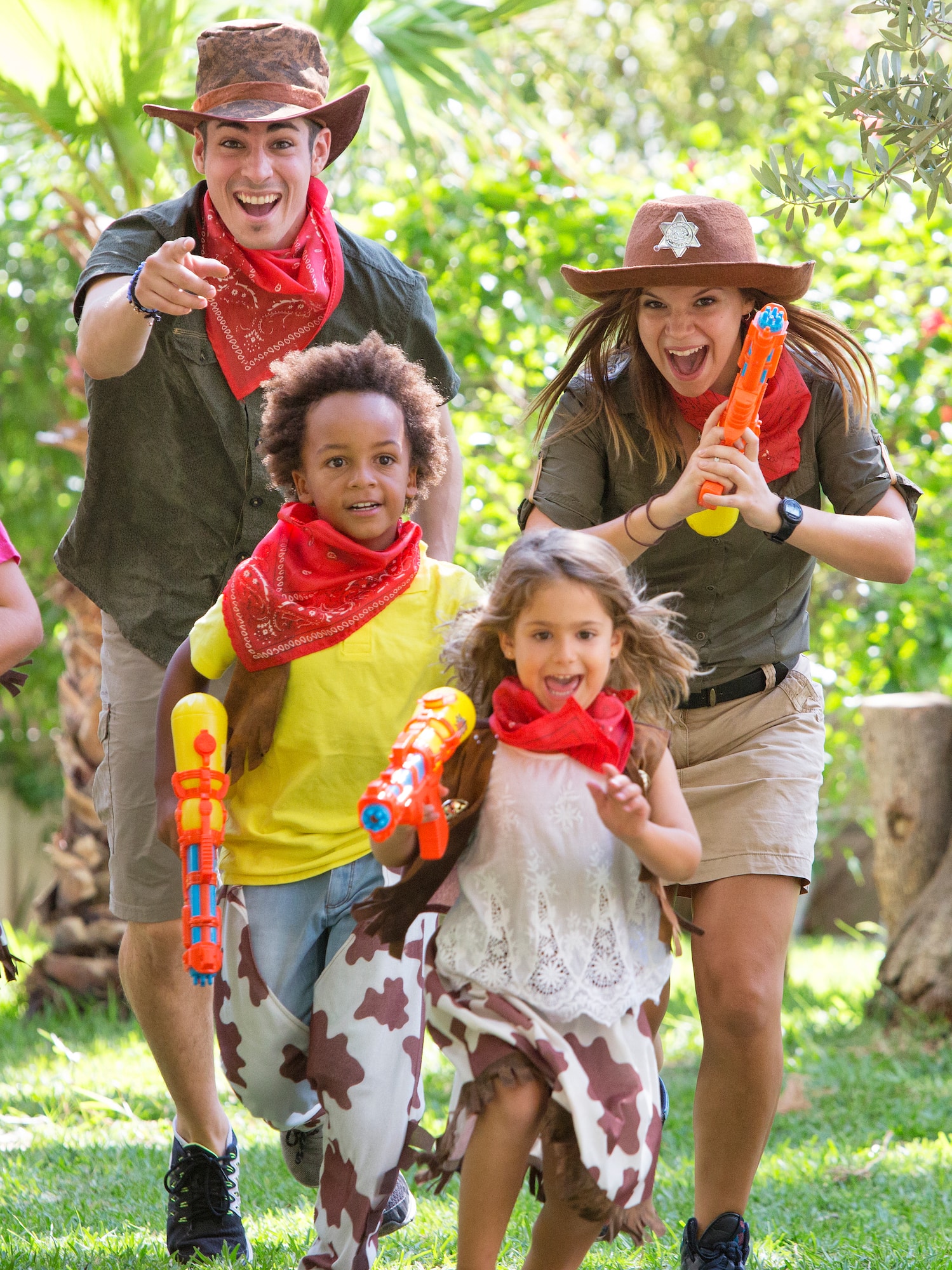 a group of people wearing cowboy hats and holding water guns