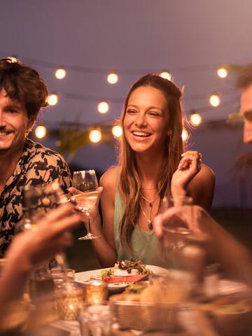 a group of people sitting at a table with drinks