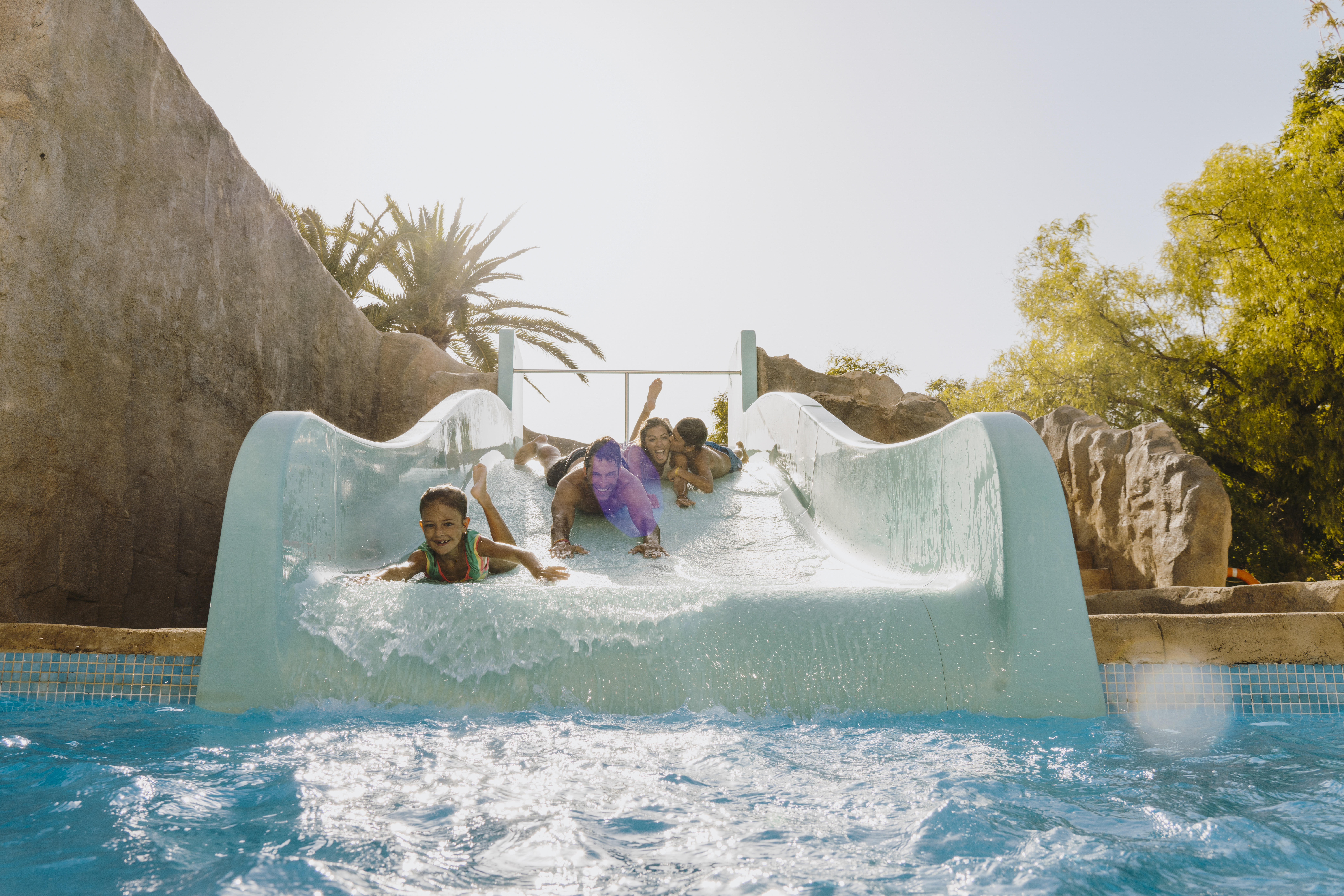 a group of kids on a water slide