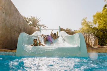a group of kids on a water slide