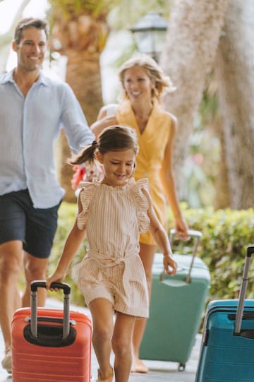 a girl running with a man and woman in the background