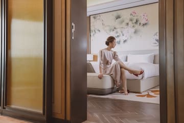 a woman sitting on a bed