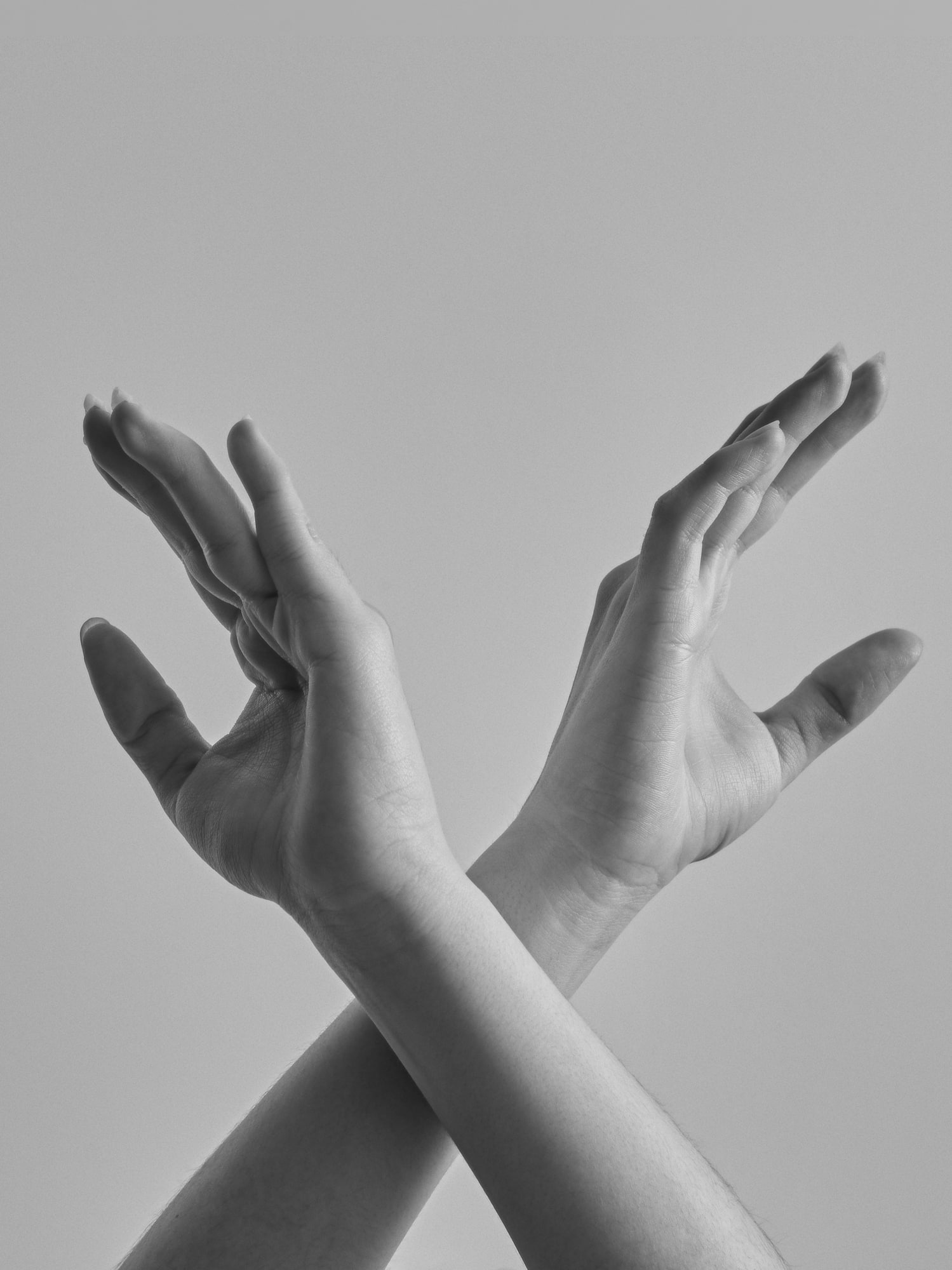 a pair of hands with their hands crossed