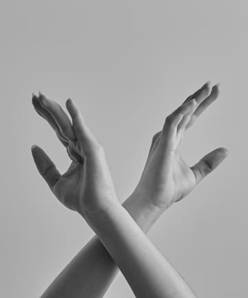 a pair of hands with their hands crossed