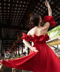 a woman in a red dress dancing