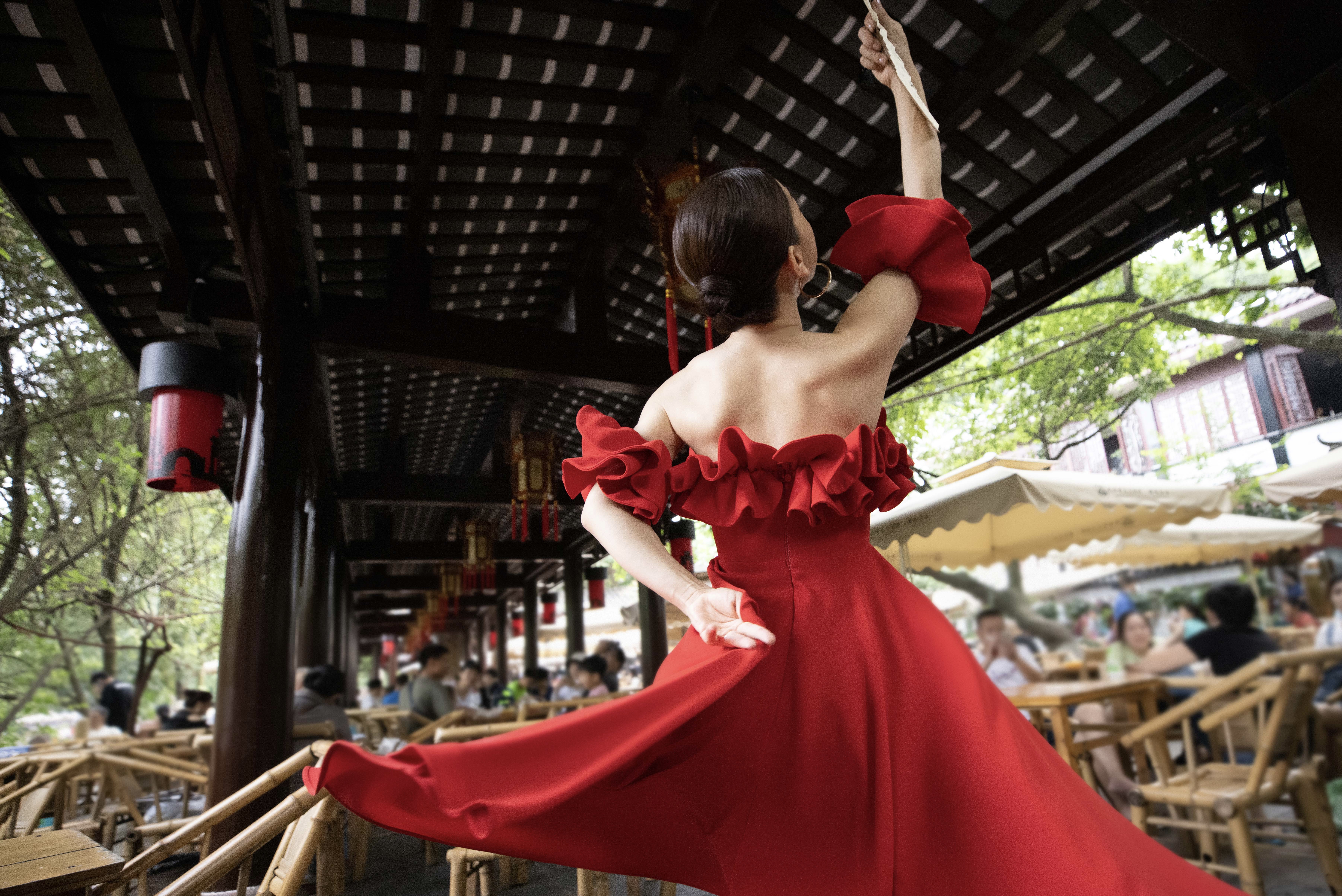 a woman in a red dress dancing