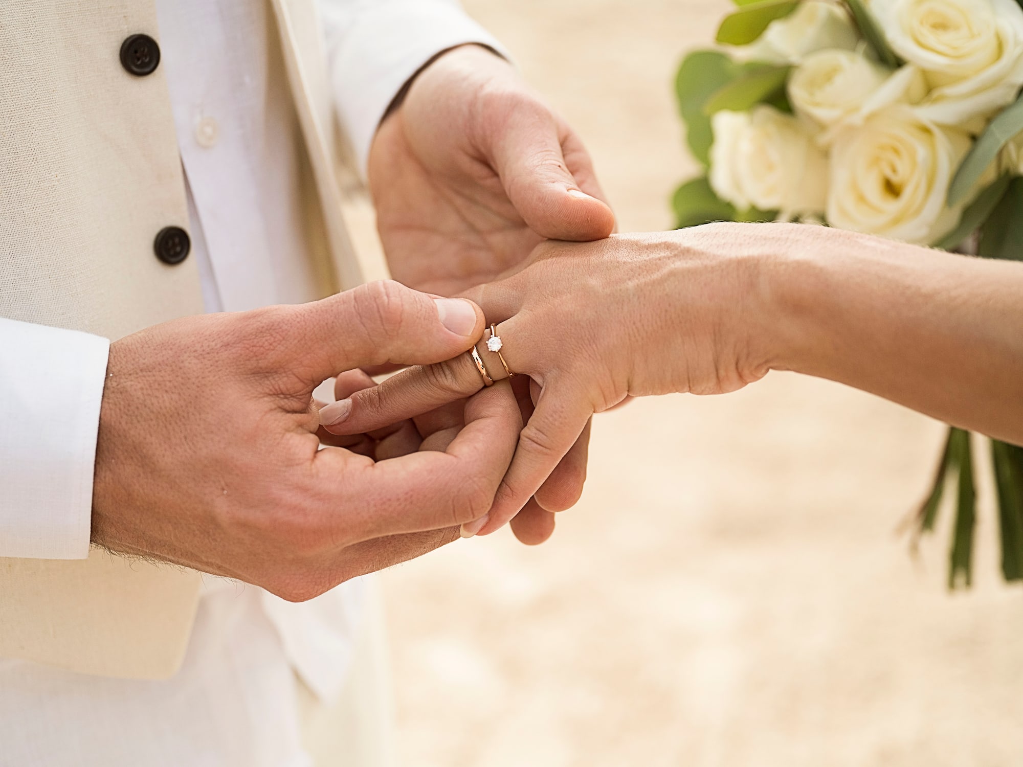 a man putting a ring on a woman's hand