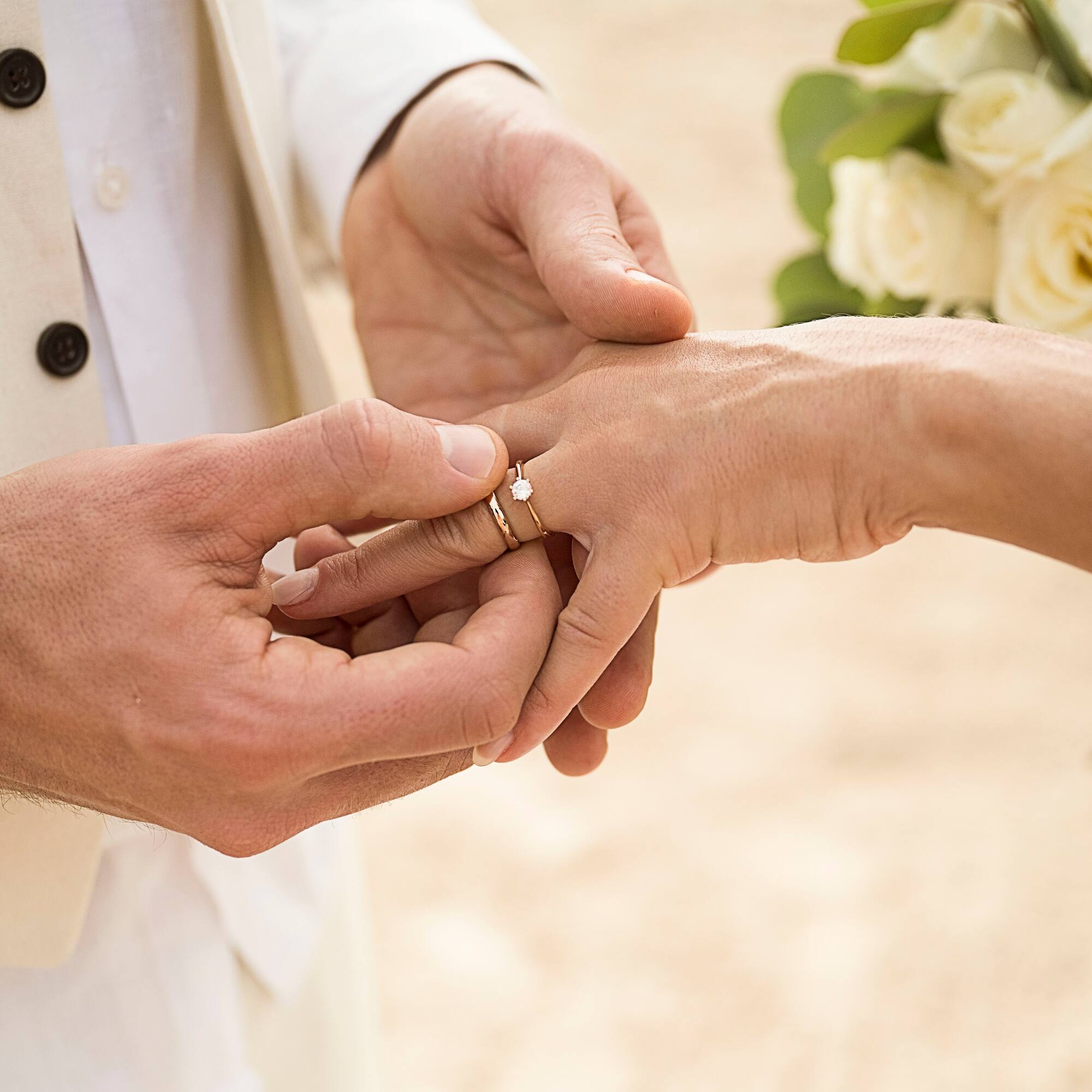 a man putting a ring on a woman's hand