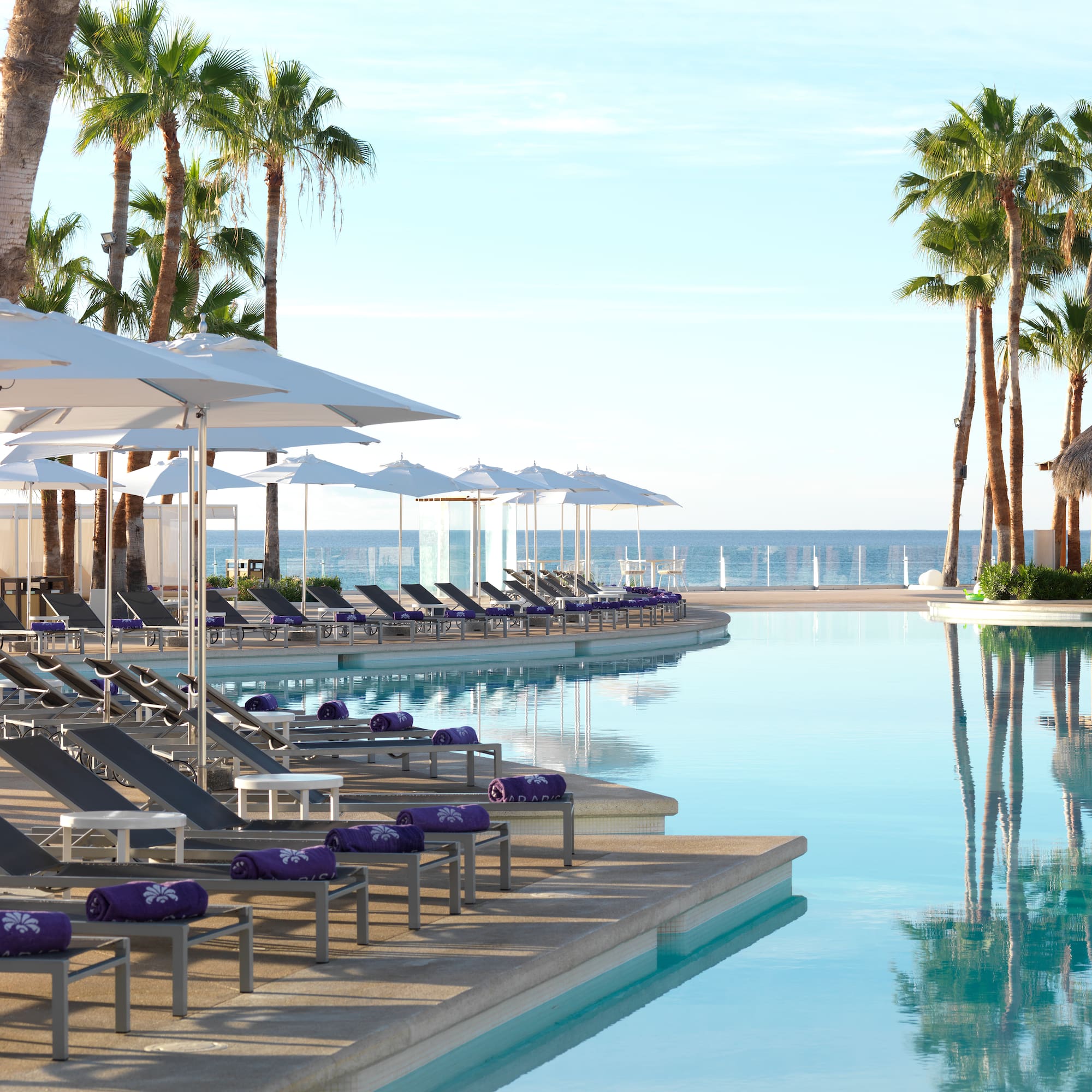 a pool with lounge chairs and umbrellas