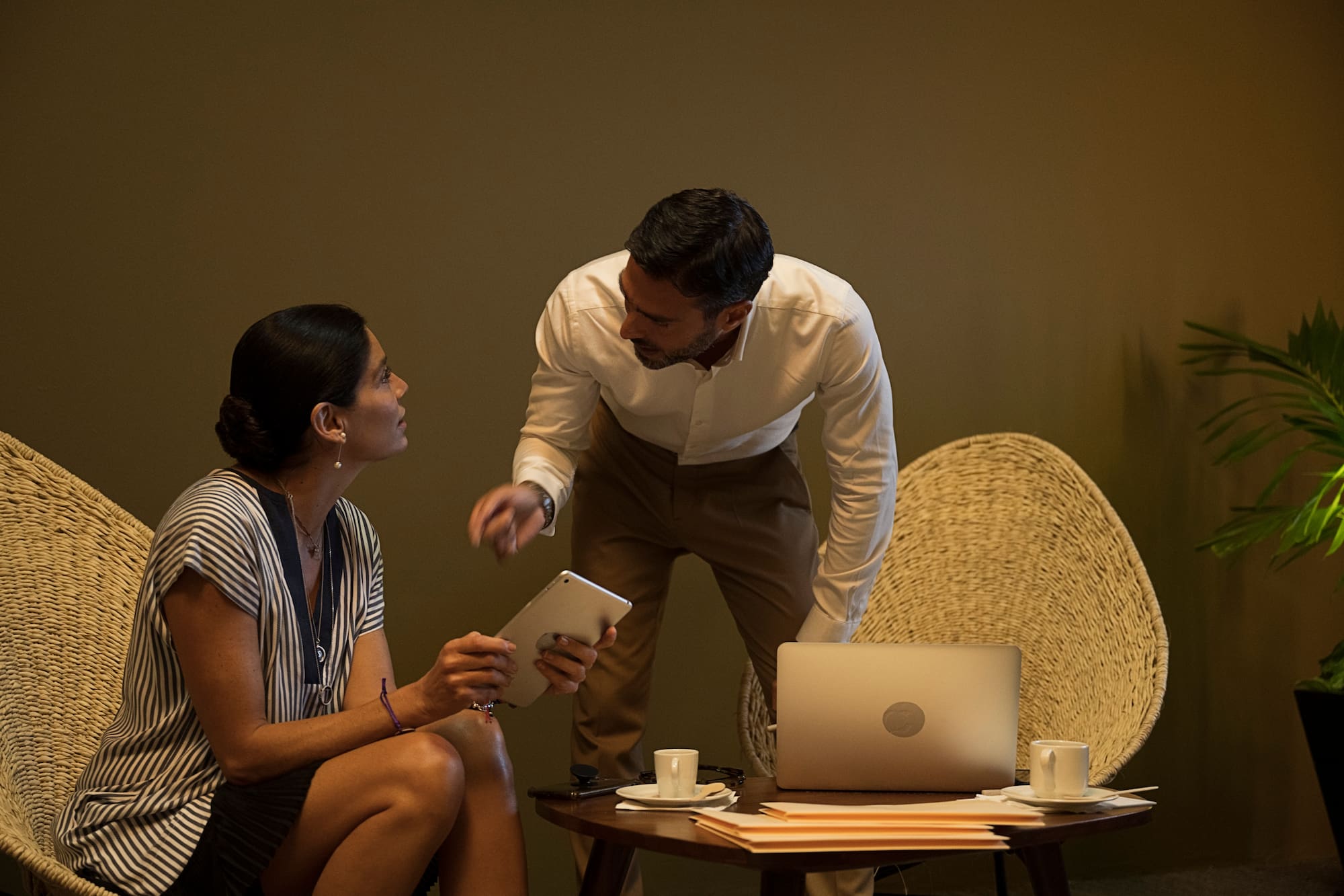 a man and woman looking at a tablet