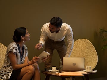 a man and woman looking at a tablet