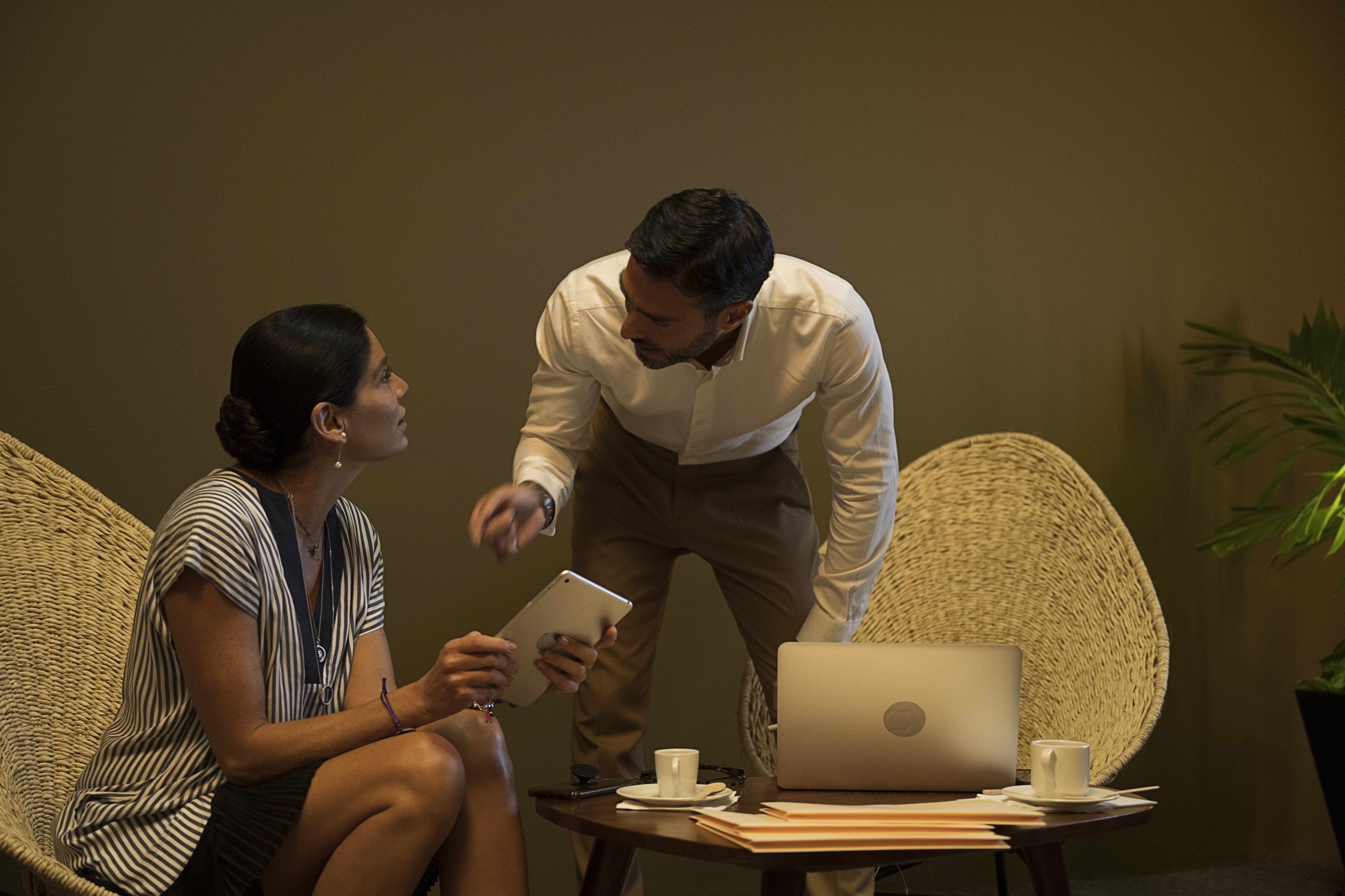 a man and woman looking at a tablet
