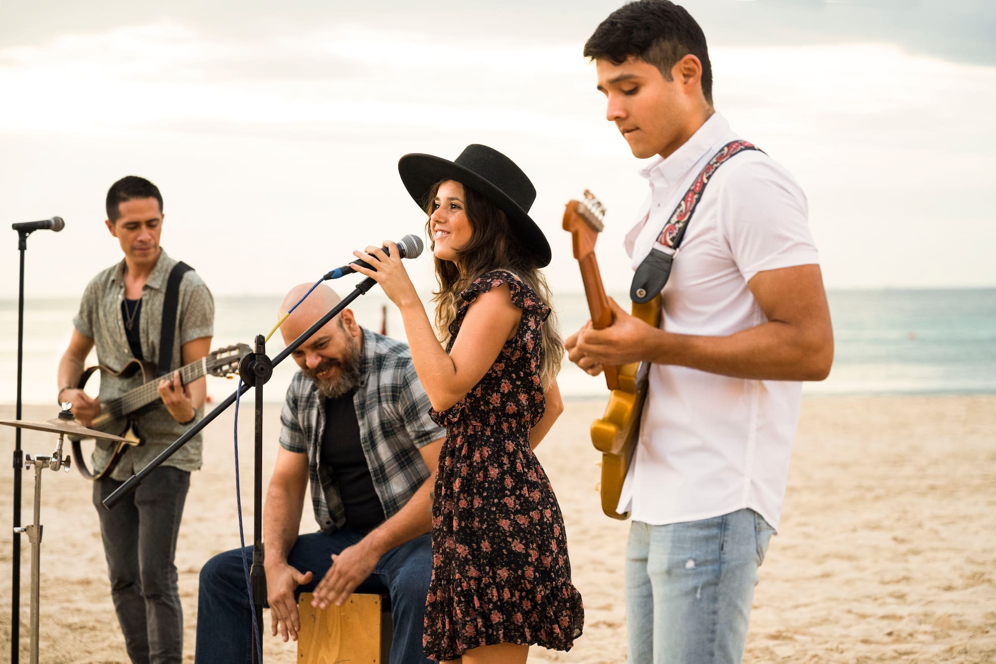a group of people playing instruments on a beach
