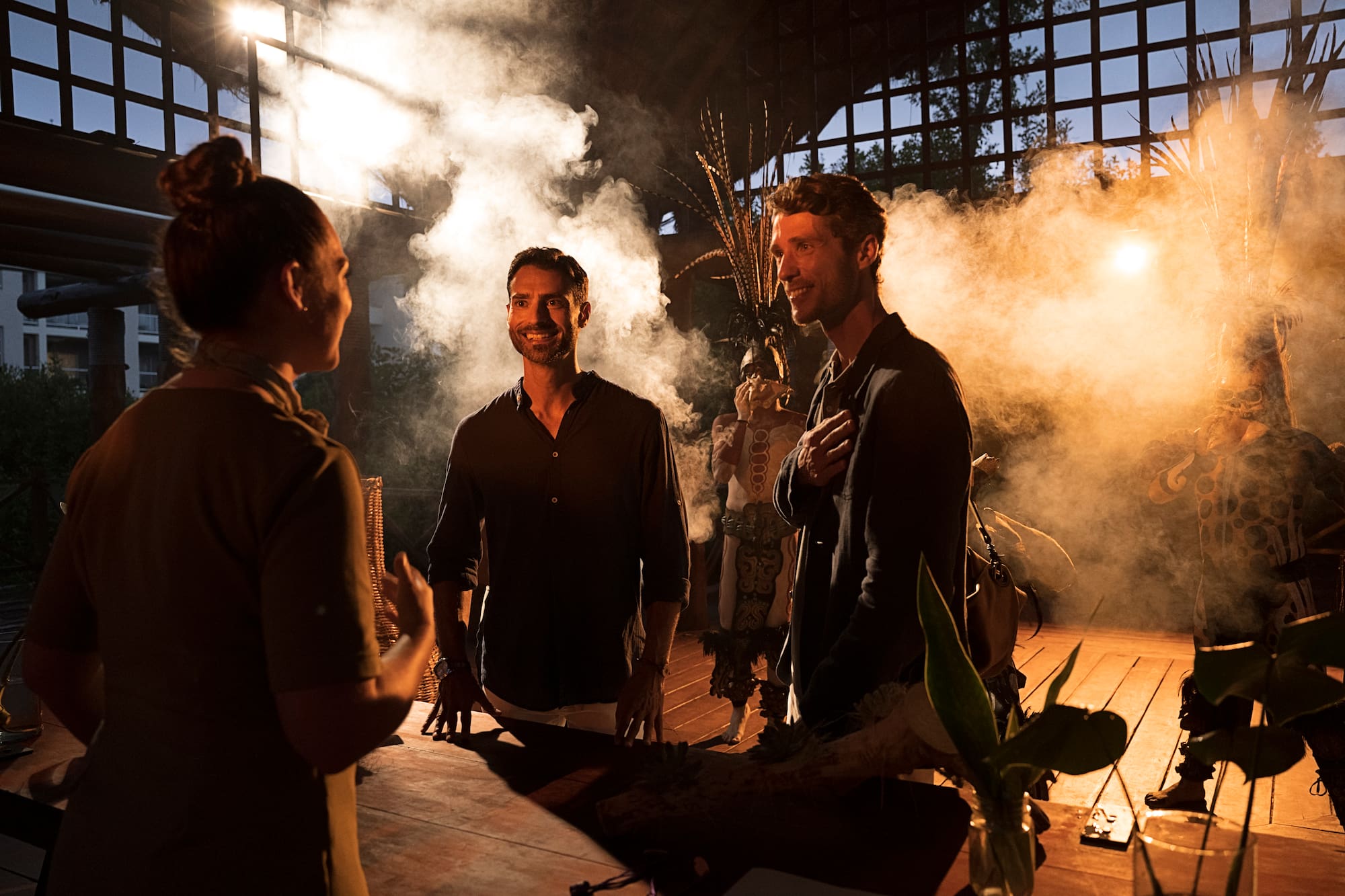 a group of people standing around a table