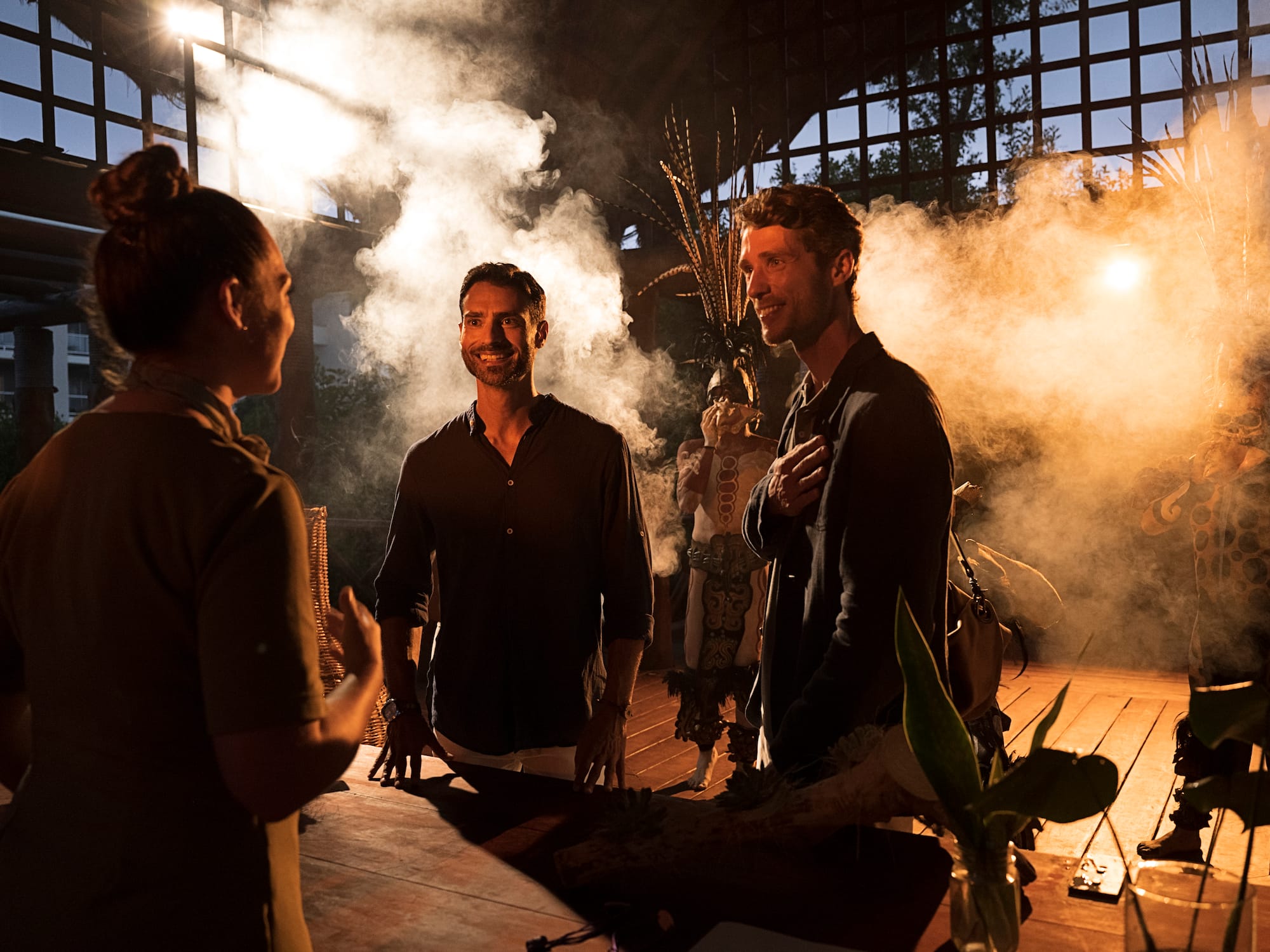 a group of people standing around a table