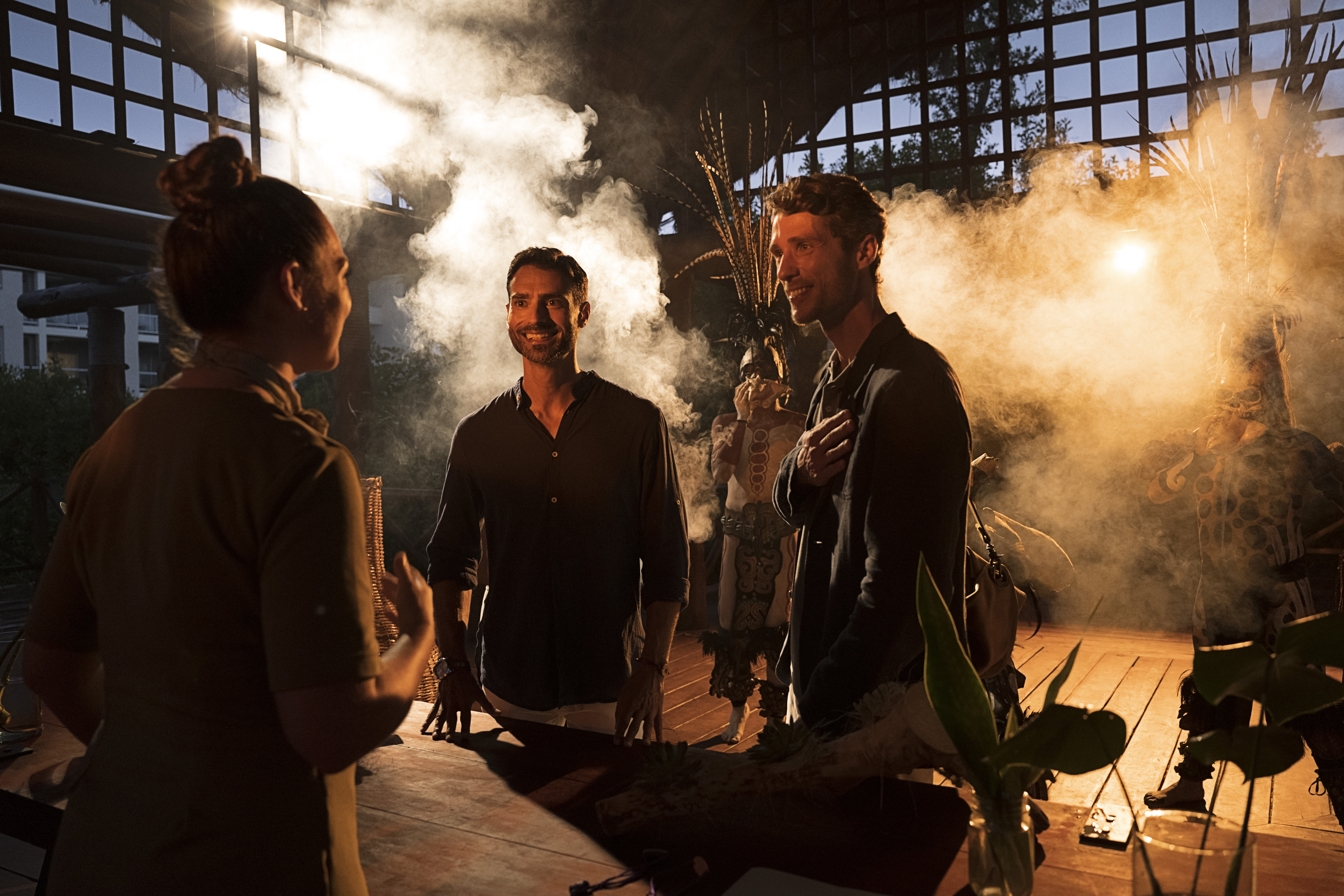 a group of people standing around a table