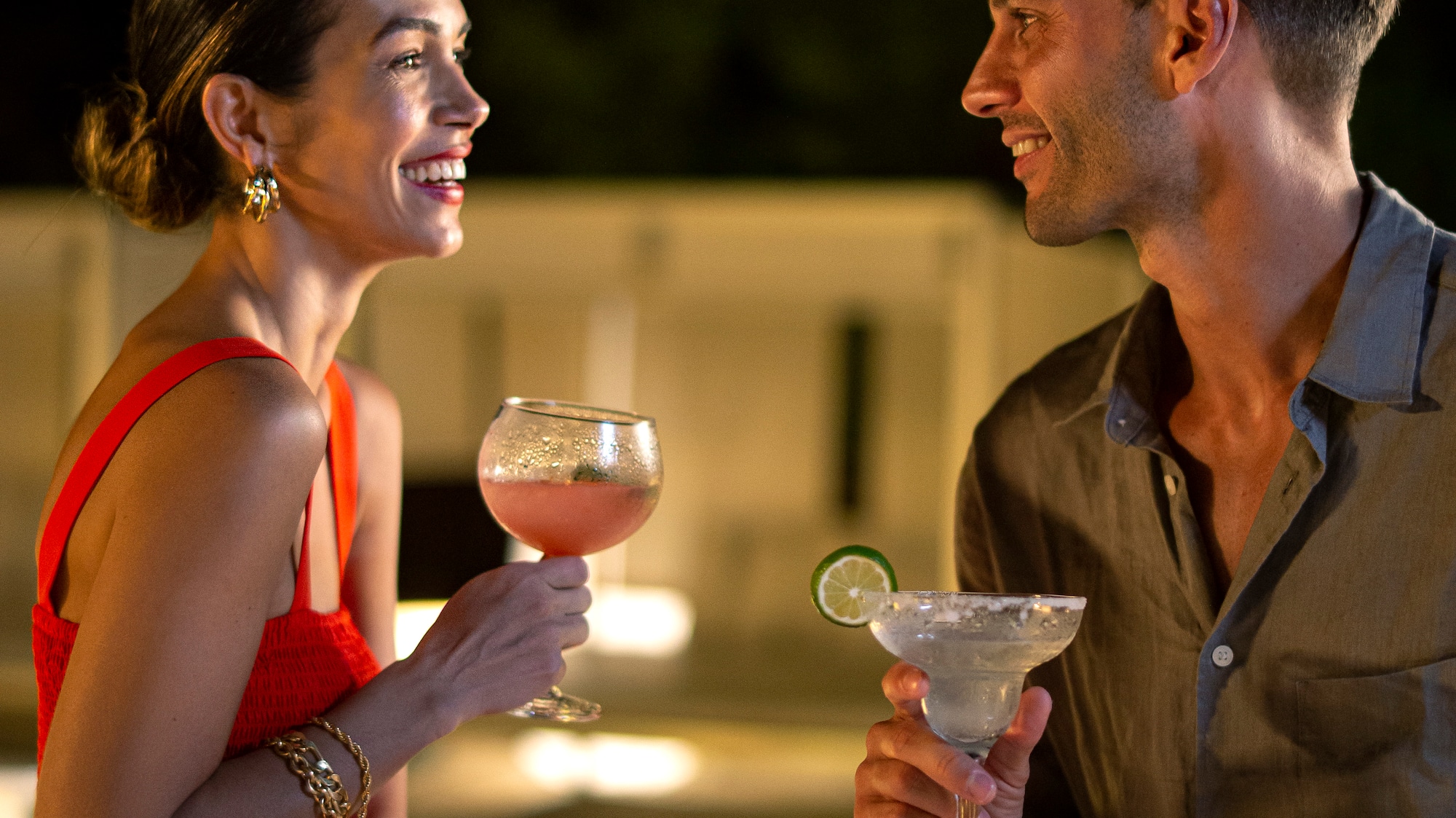 a man and woman holding drinks
