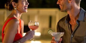 a man and woman holding drinks