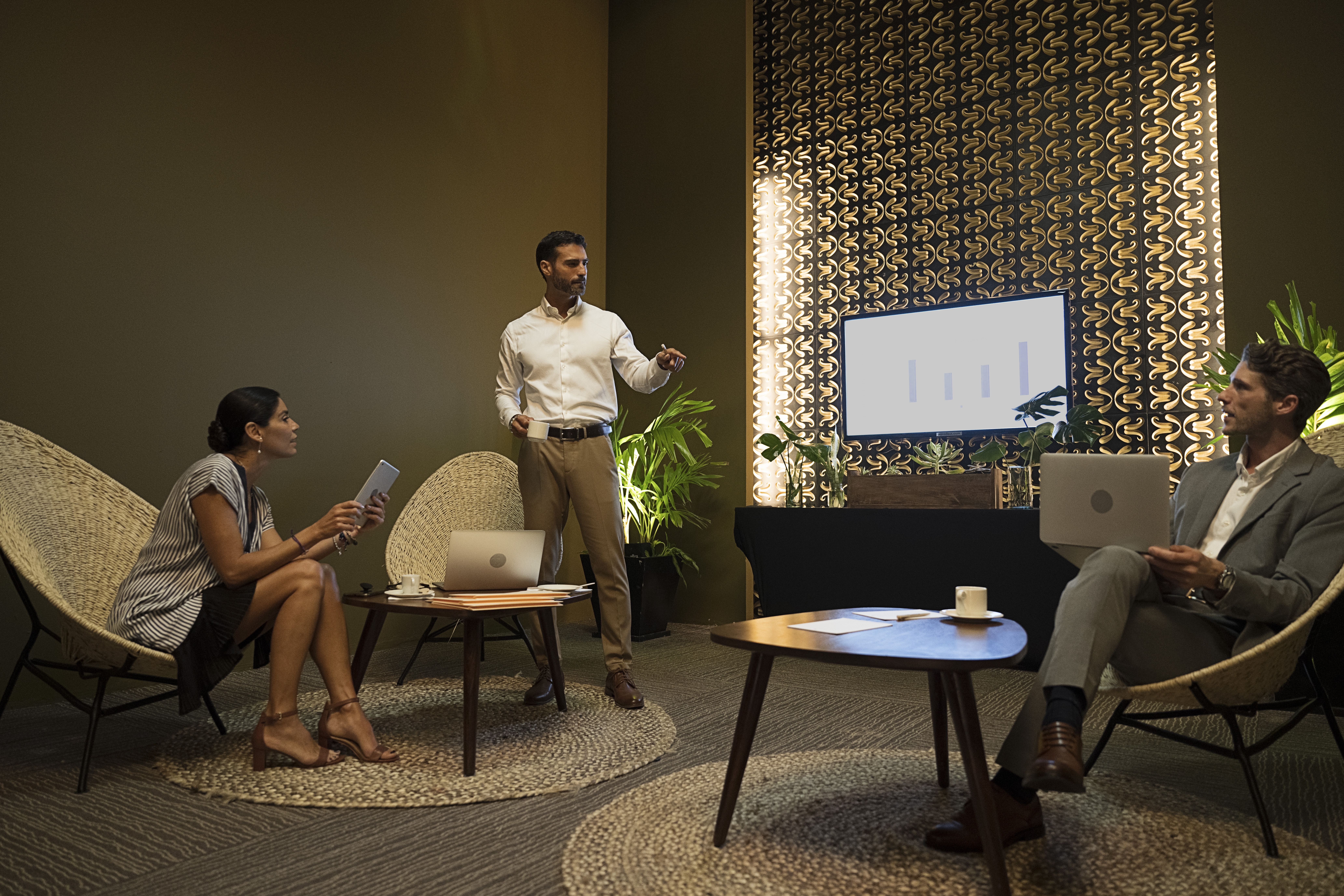a man standing in front of a man with a laptop
