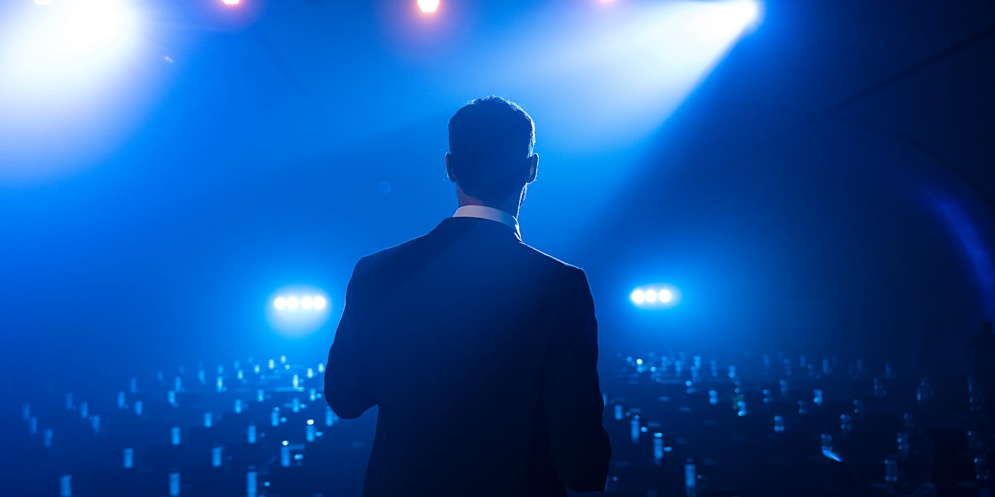a man standing in a room with lights