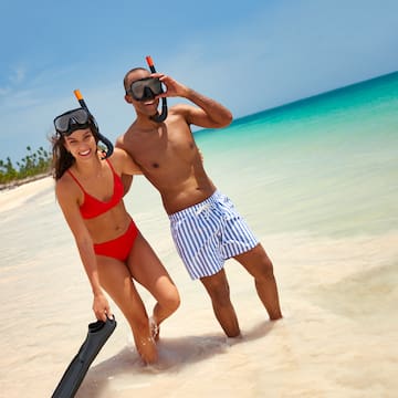 a man and woman in swimsuits on a beach