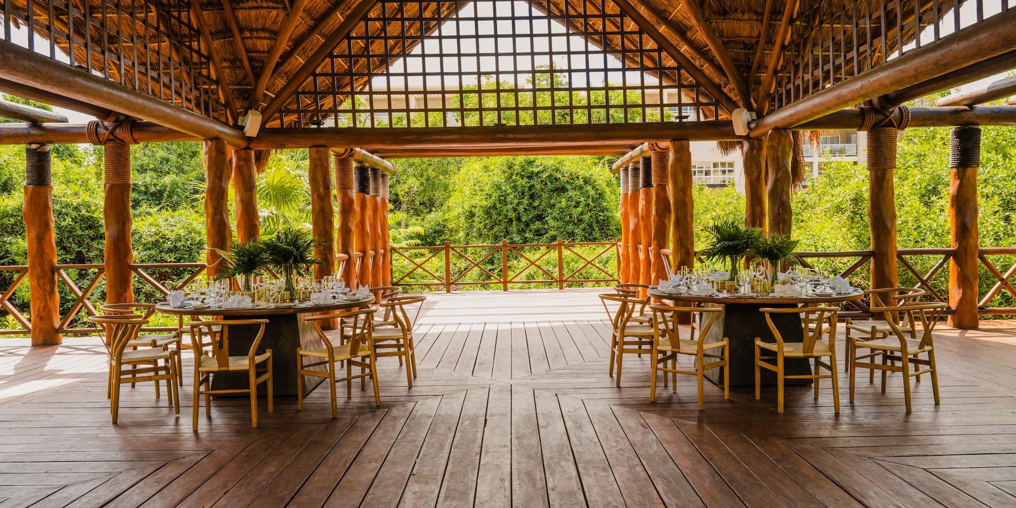 a wooden patio with tables and chairs