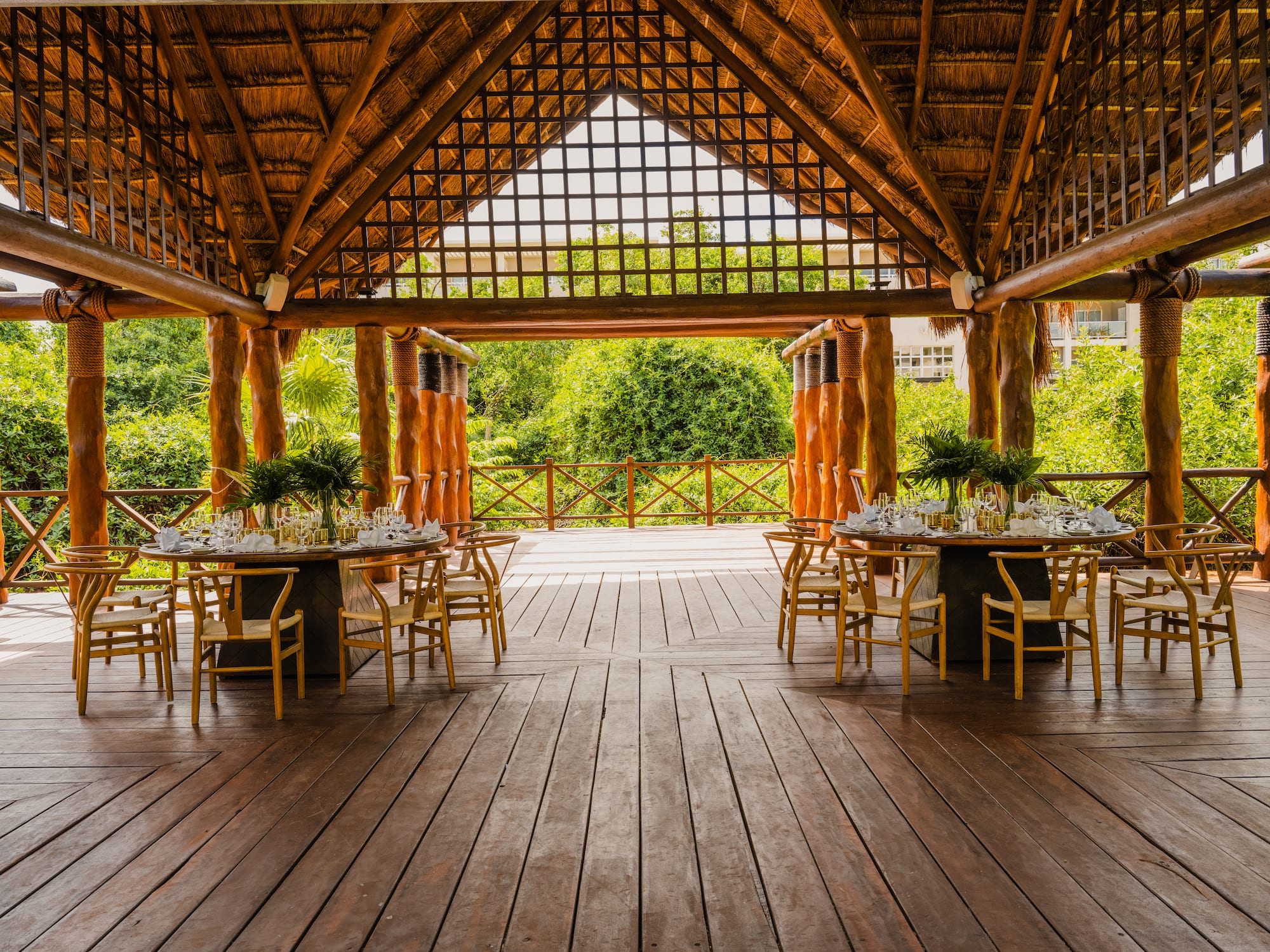a wooden patio with tables and chairs