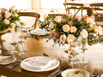 a table set with flowers and glasses