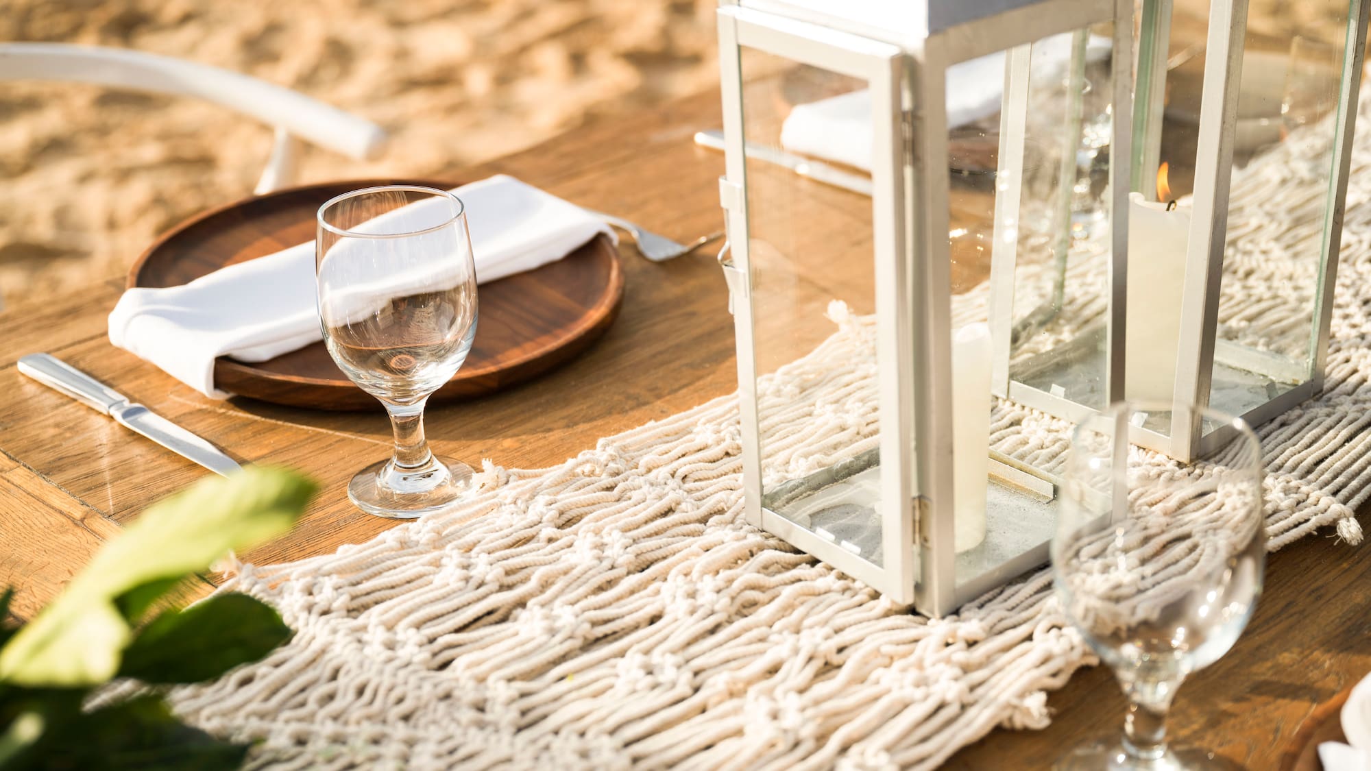 a table with a lantern and wine glasses on it