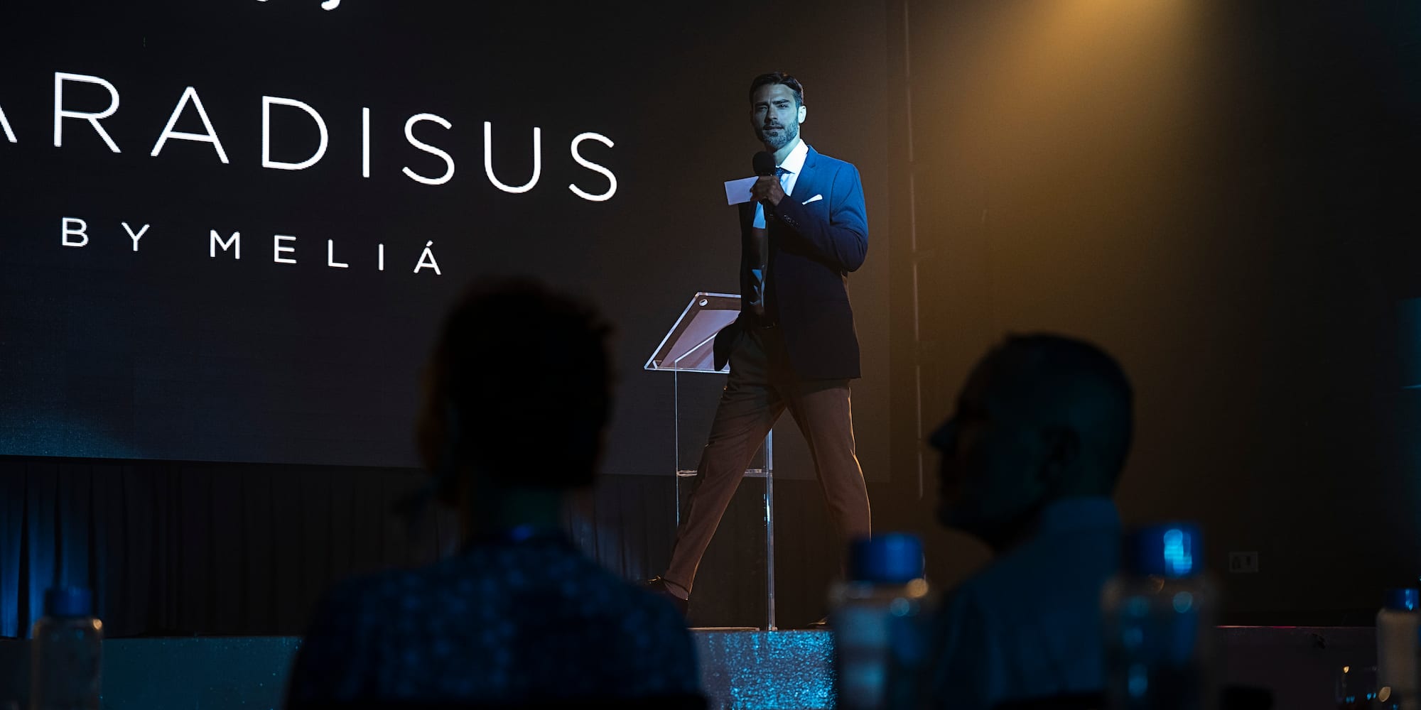 a man standing on a stage with a microphone