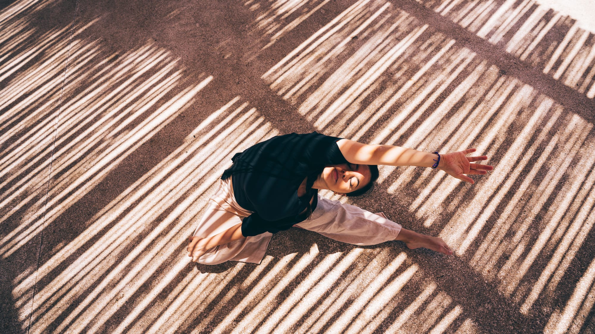 a woman doing yoga on the ground