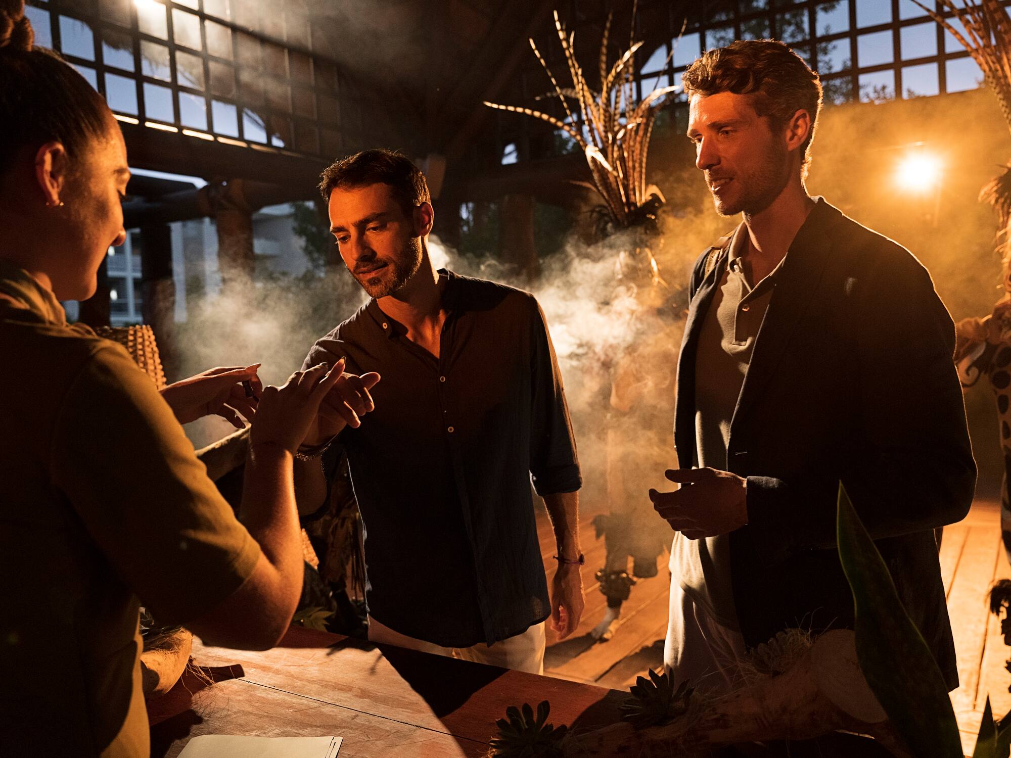 a group of men standing around a table