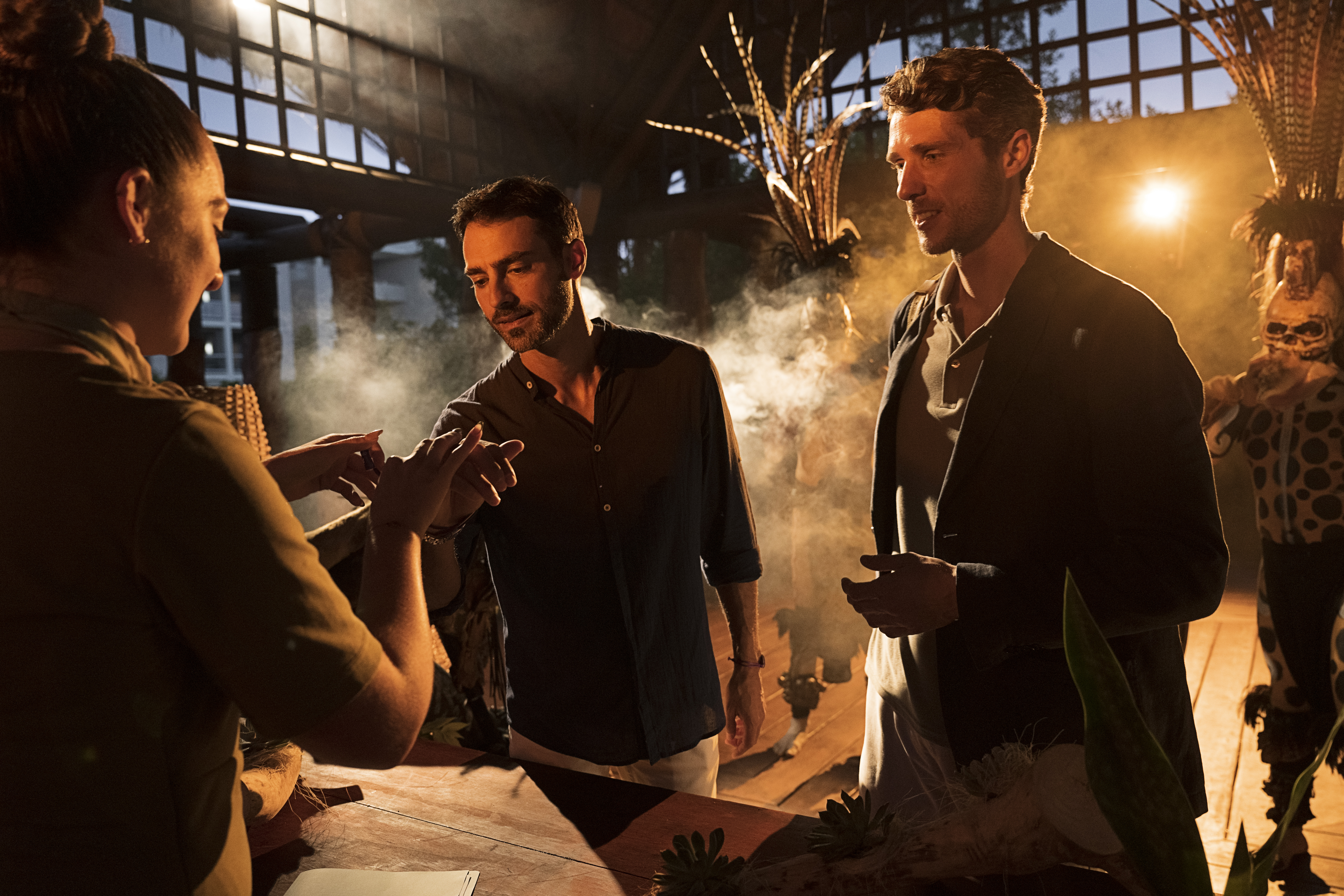 a group of men standing around a table