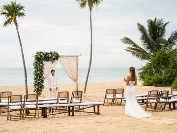 a bride and groom on a beach