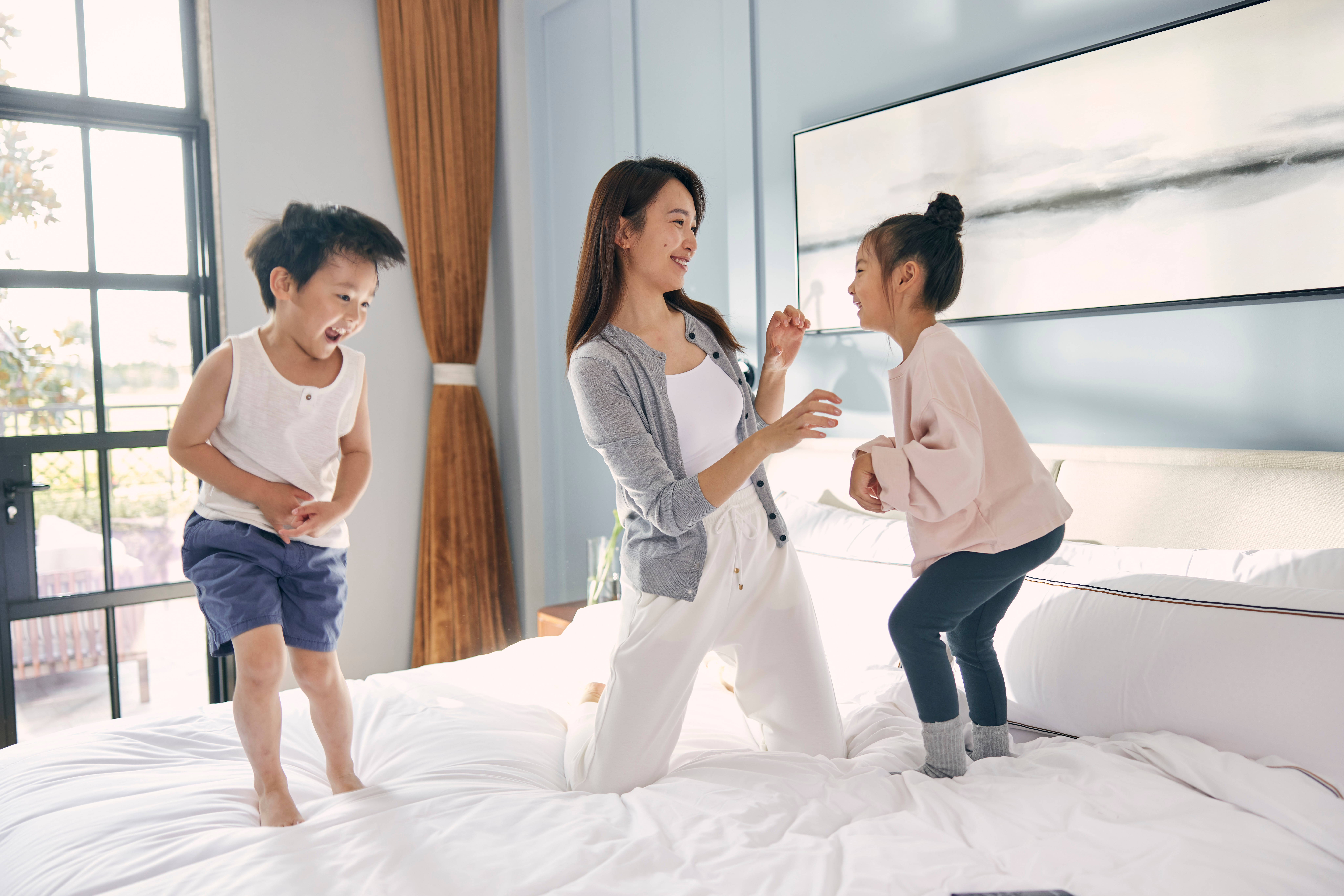 a woman and children on a bed