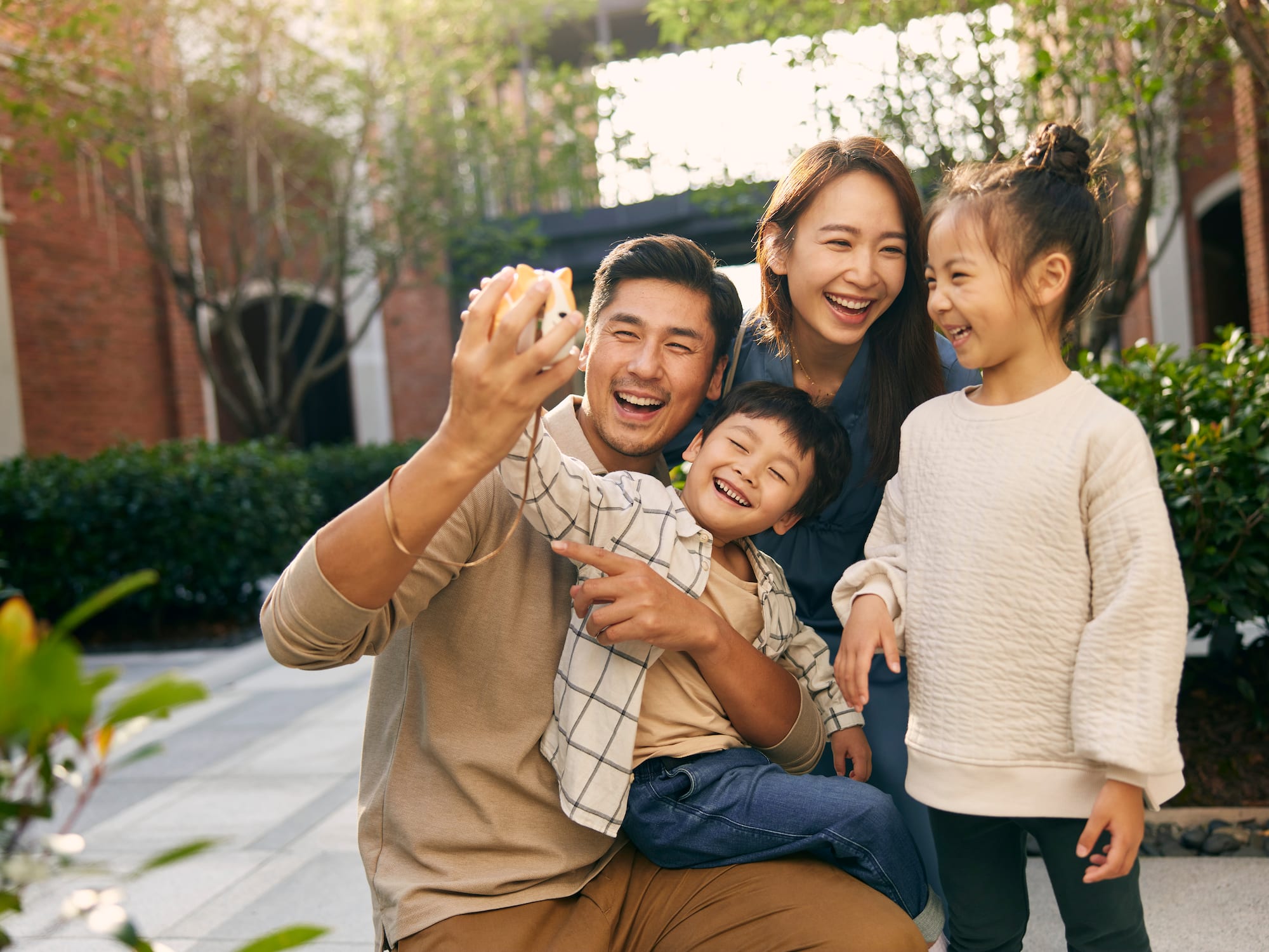 a man and woman taking a selfie with children