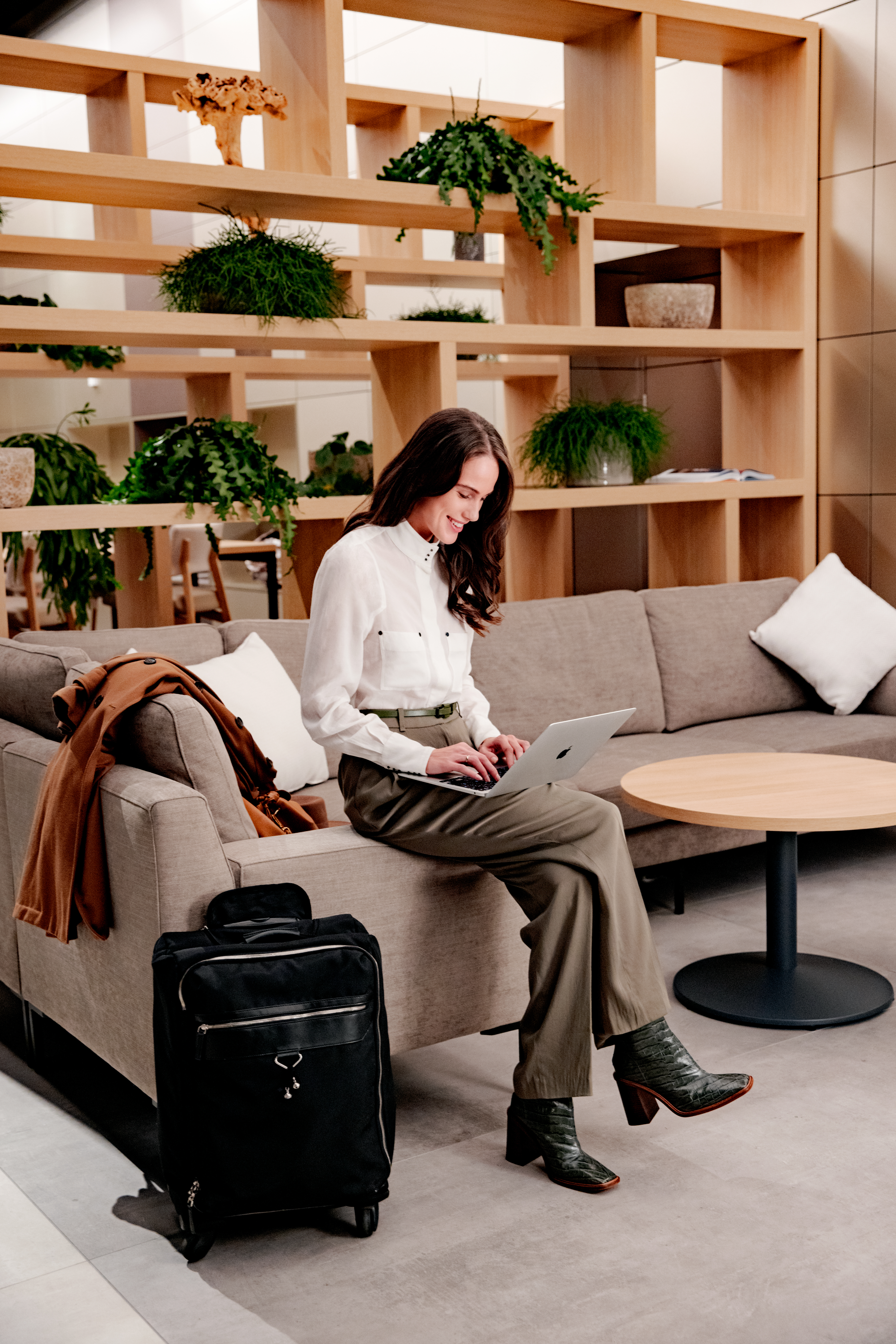 a woman sitting on a couch using a laptop